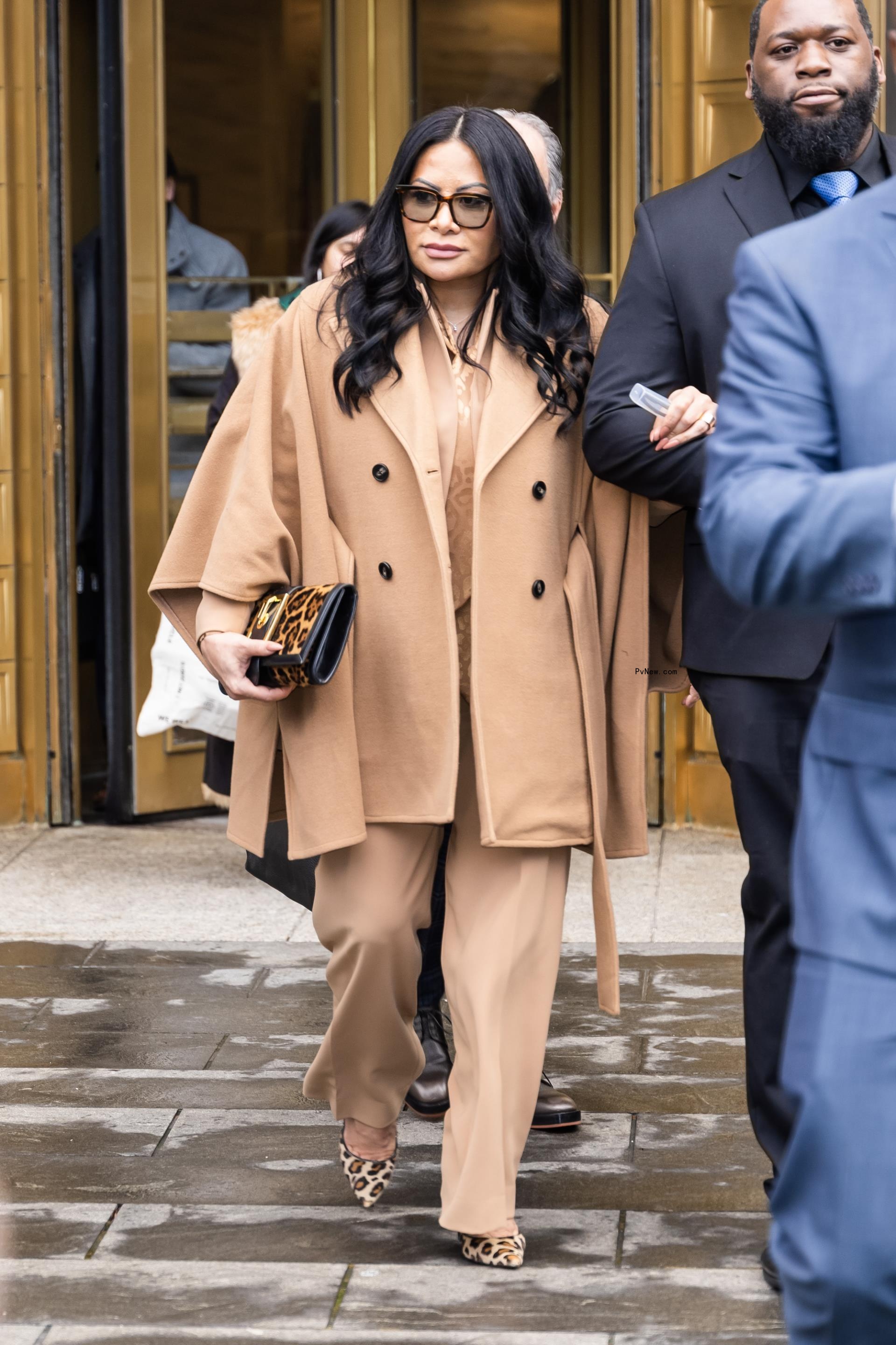 jen shah walking out of court with her arm l<i></i>inked to a tall man