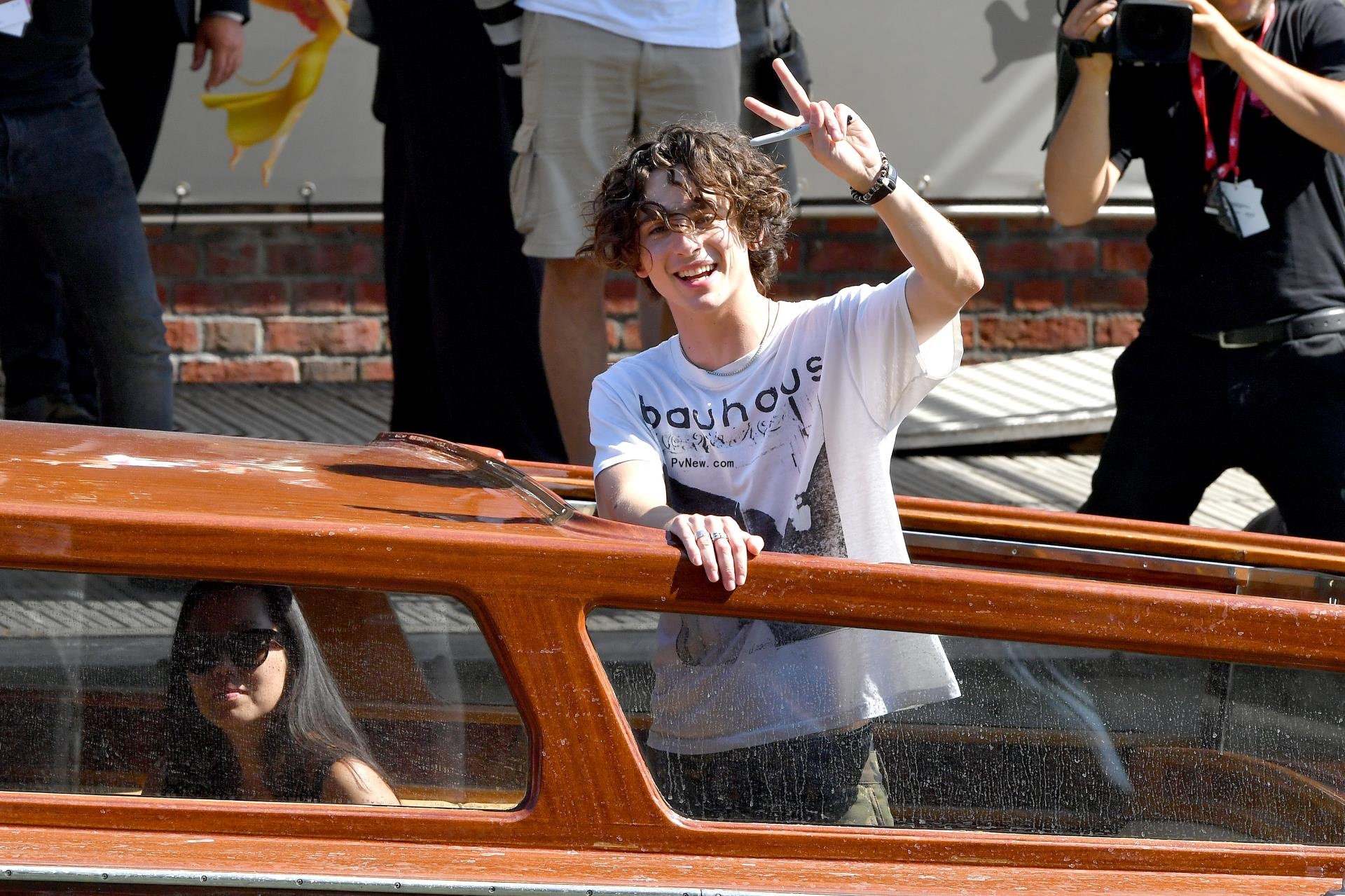 Timothée Chalamet flashes peace sign with a smile