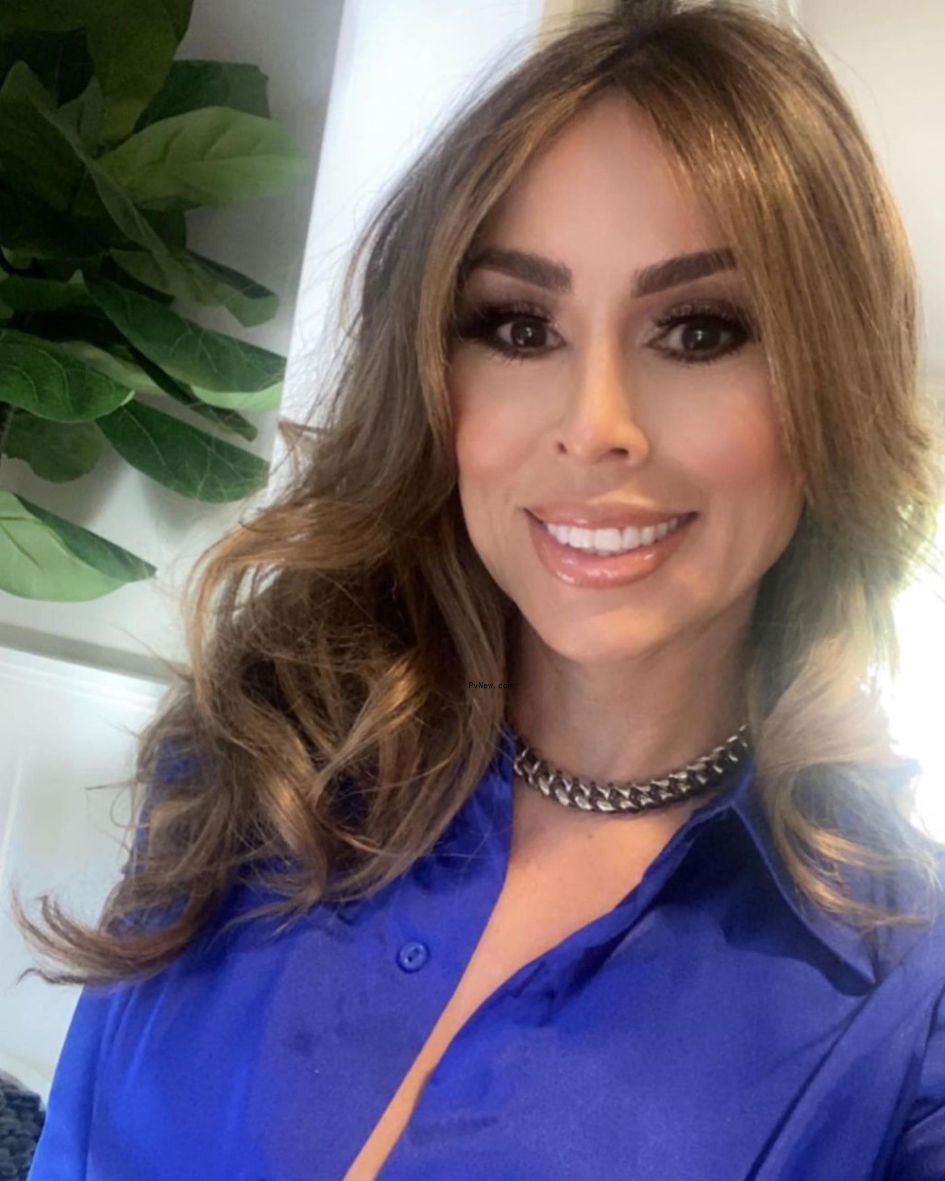 Kelly Dodd smiles in purple