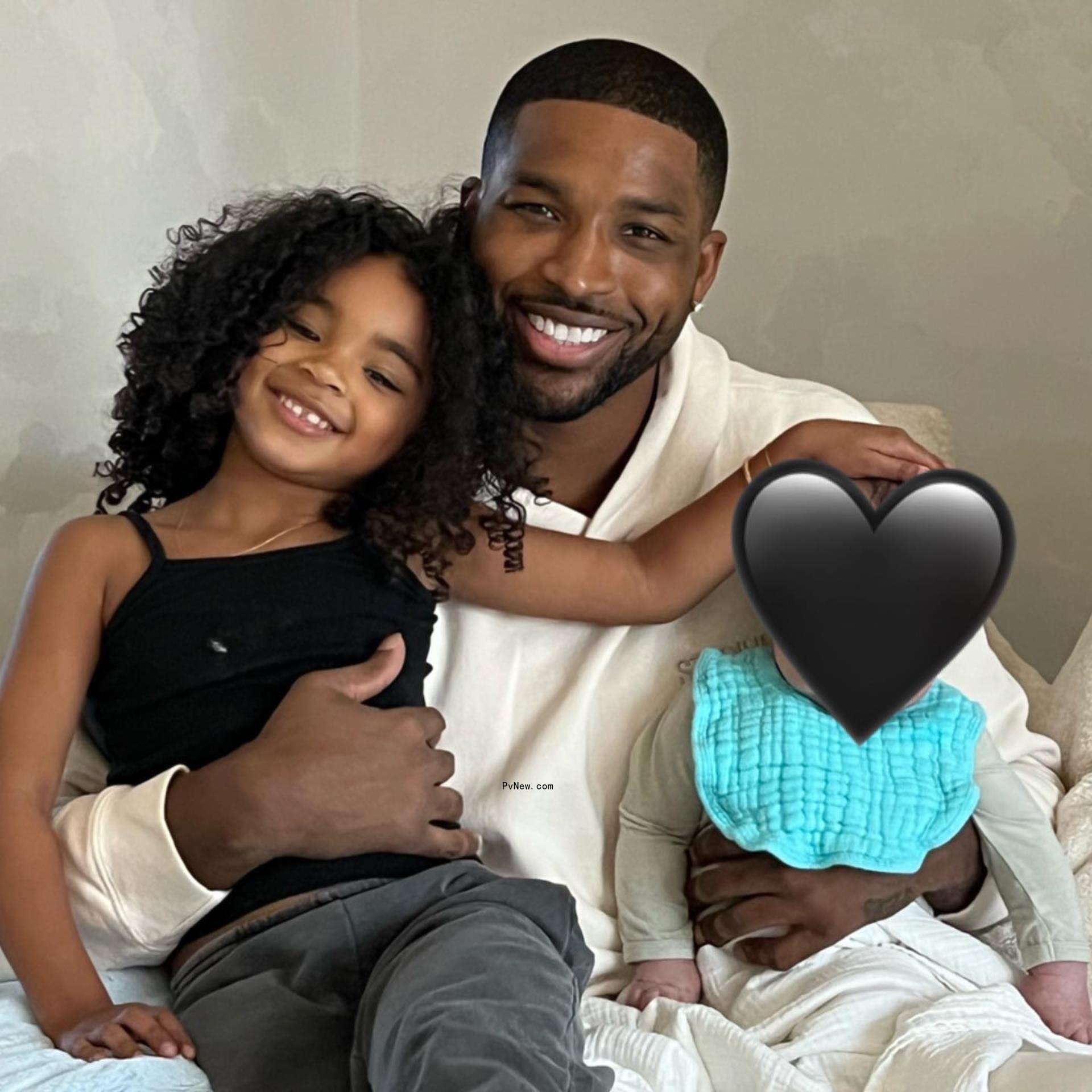 Tristan Thompson holding his kids.
