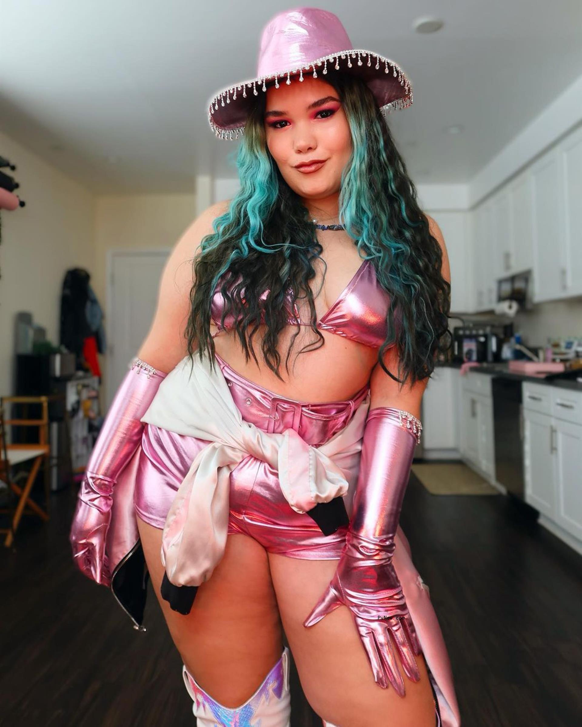Madison De La Garza posing in a pink cowgirl outfit.
