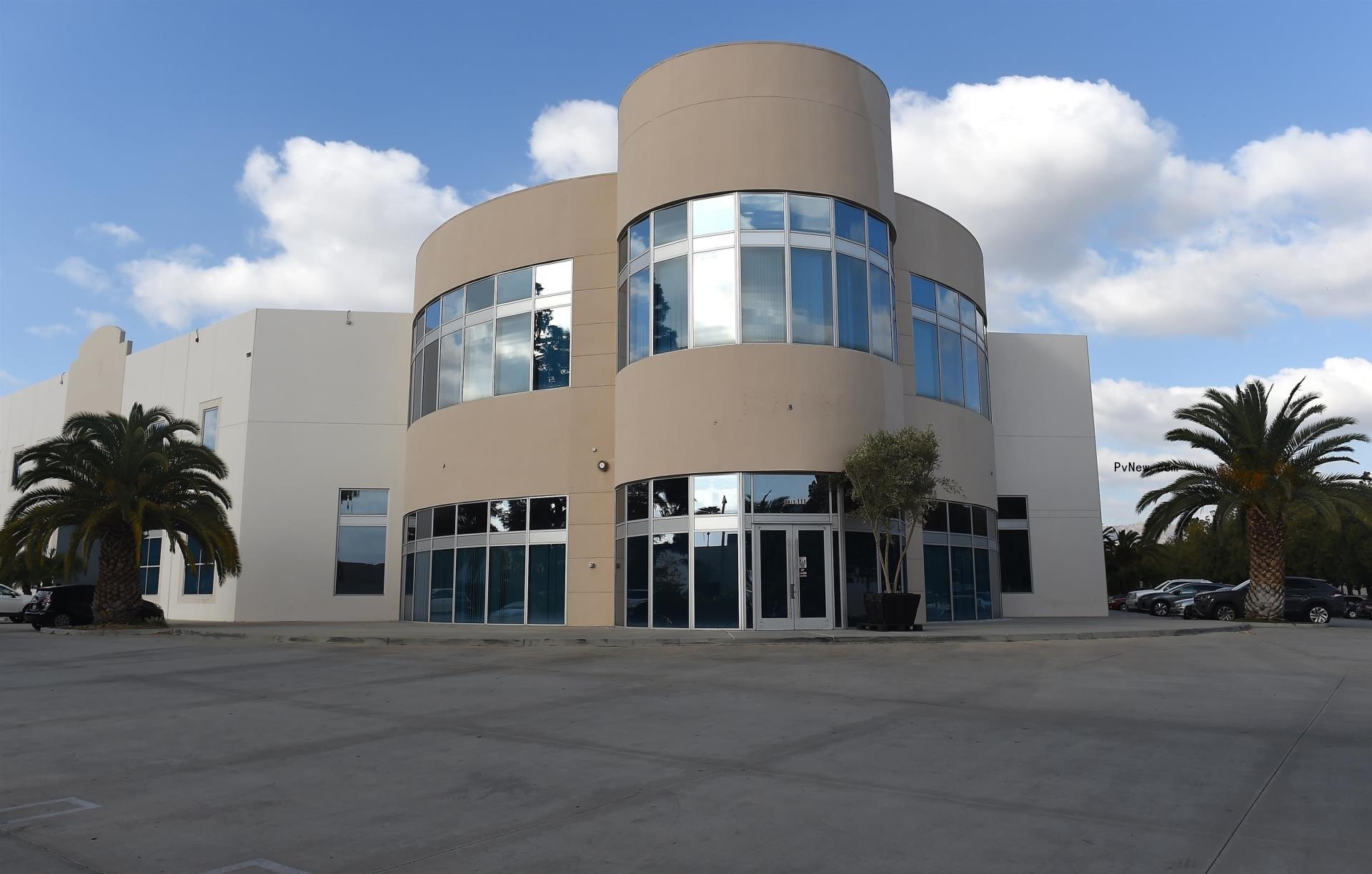 Kanye West walking in a hoodie.