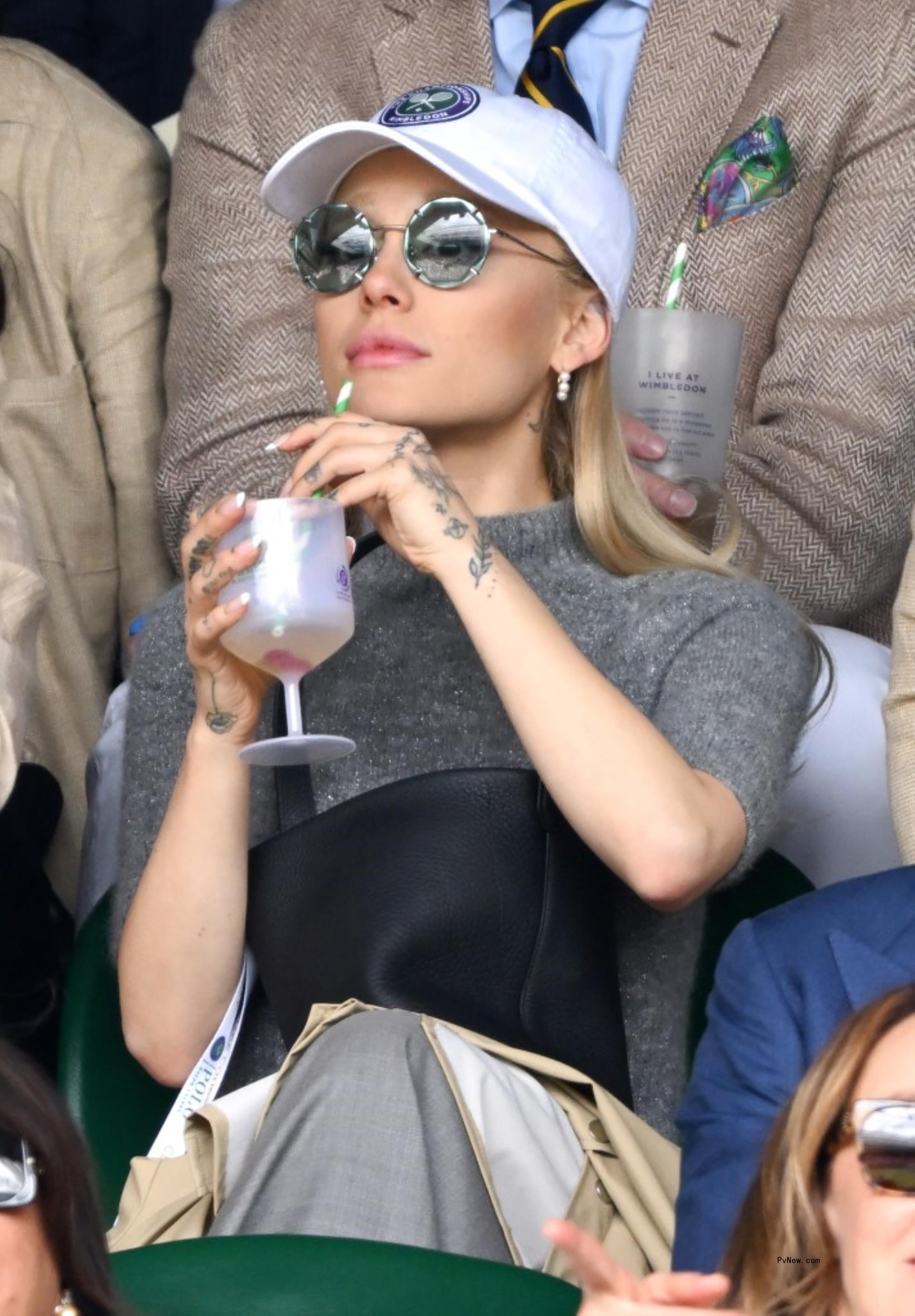 ariana grande holding a cocktail watching Wimbledon