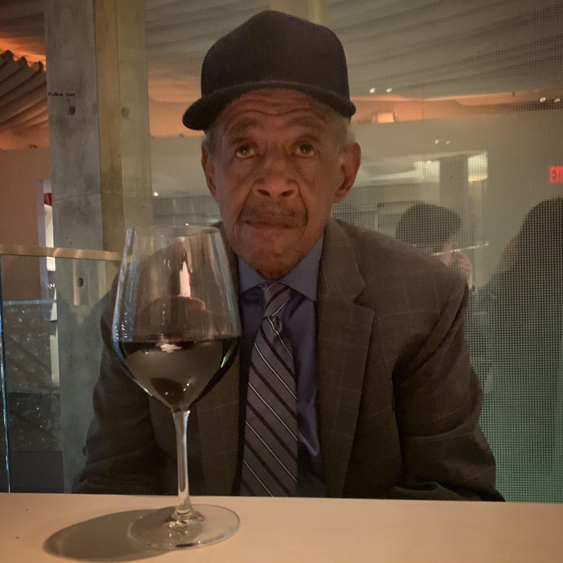 Howell Wayans sitting with a glass of wine in front of him.