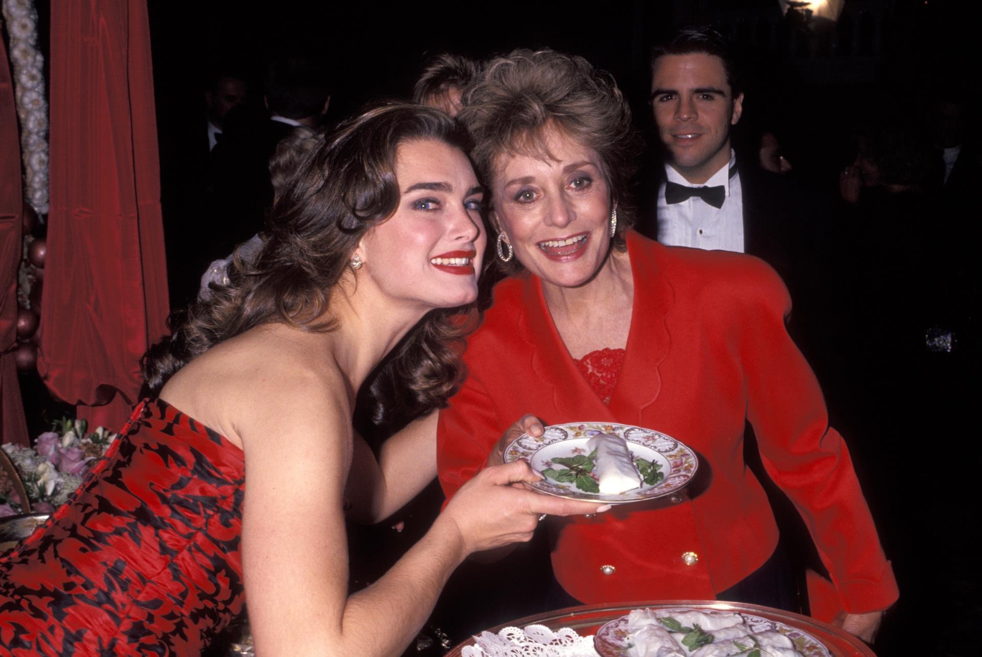 Brooke Shields and Barbara Walters posing together at a party.