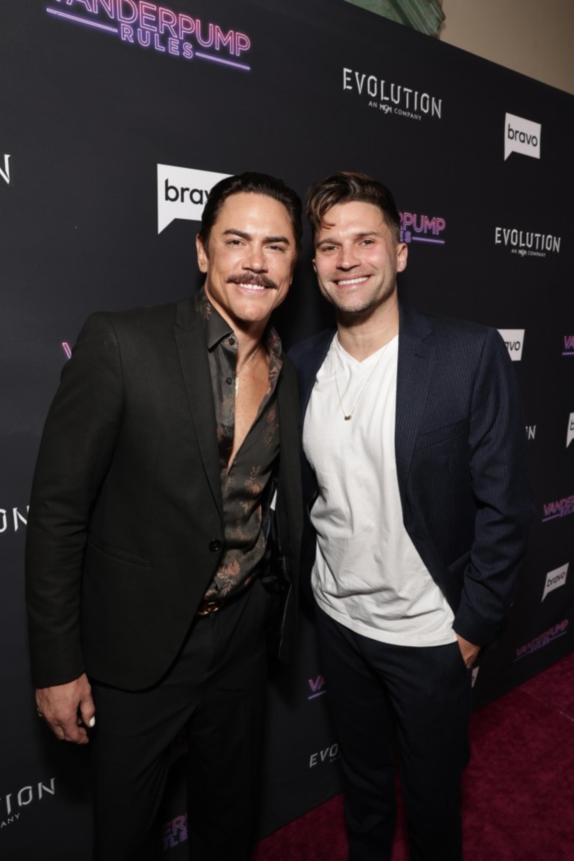 Tom Sandoval and Tom Schwartz posing together on a red carpet.