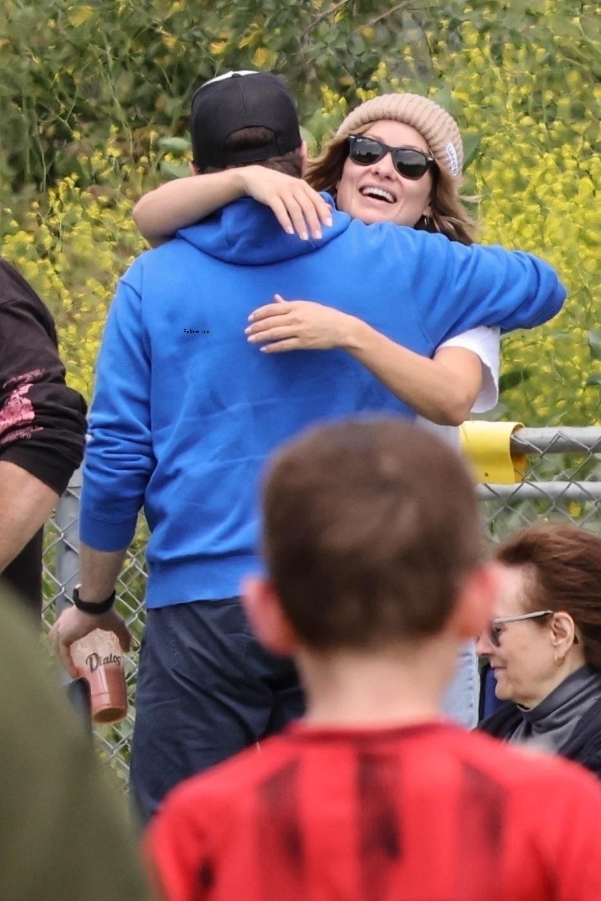 Jason Sudeikis and Olivia Wilde hugging. 