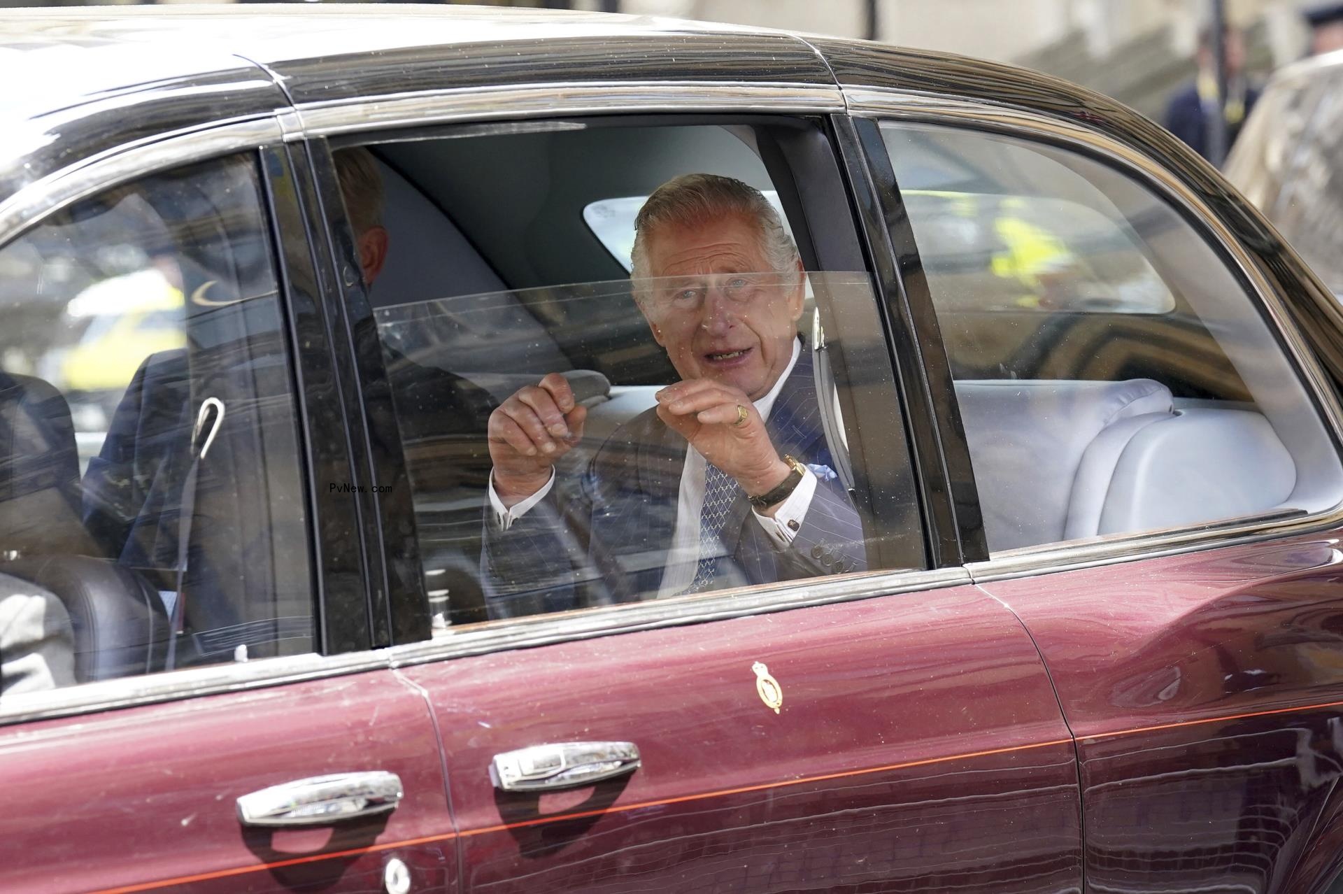 King Charles III waves from car