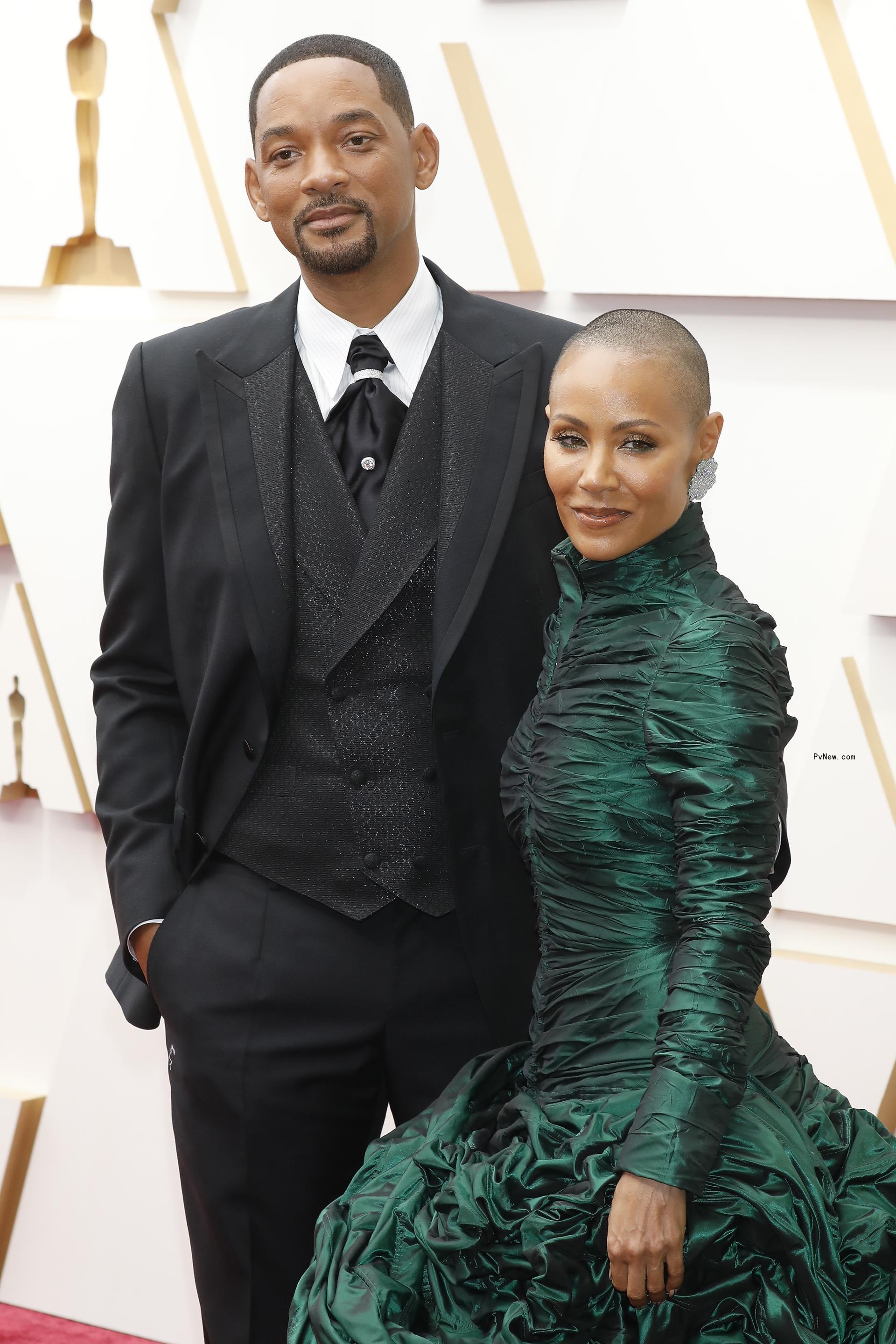 Jada Pinkett Smith wears green dress on red carpet with suited Will Smith