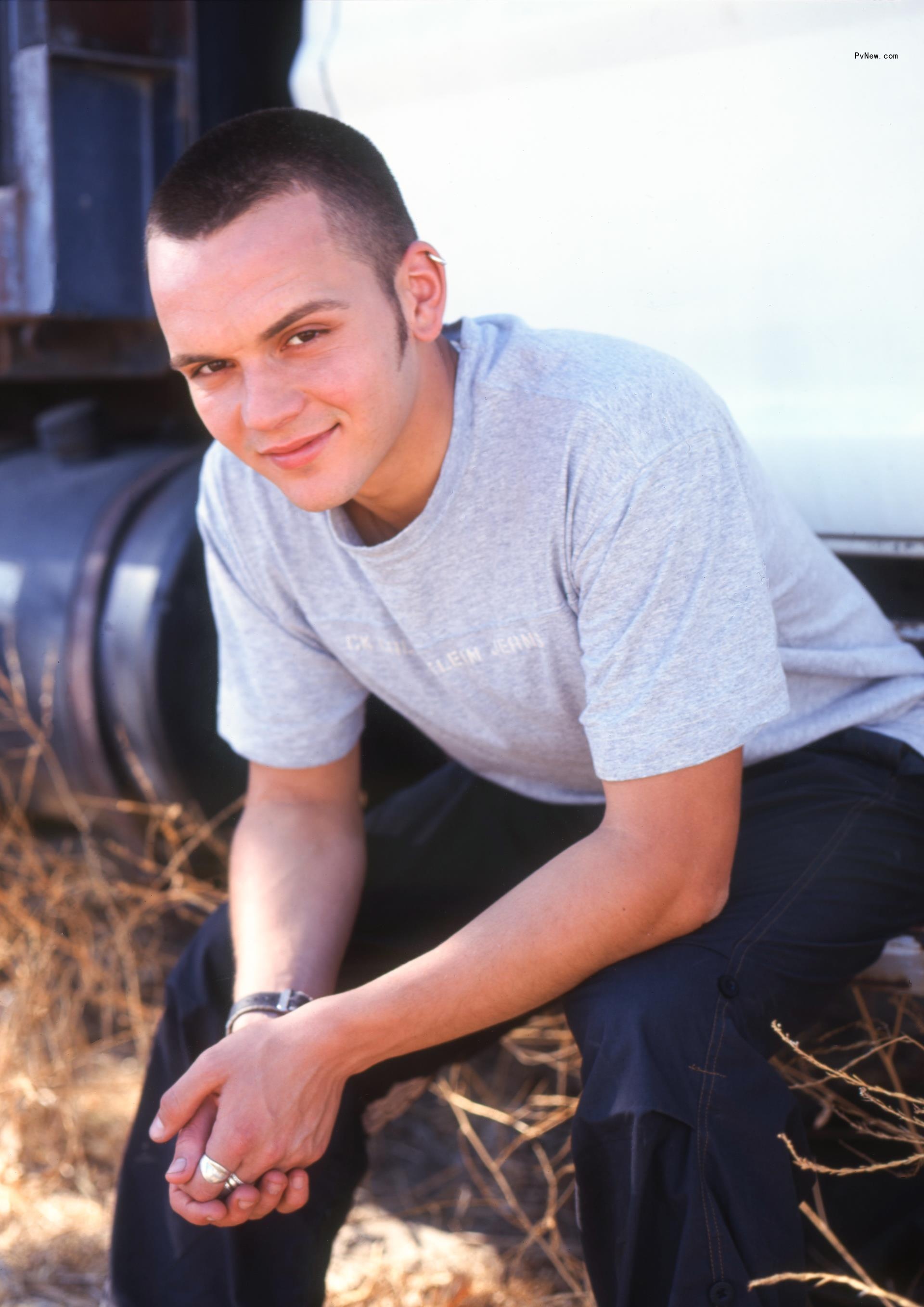 Paul Cattermole sitting on a bench in a field.