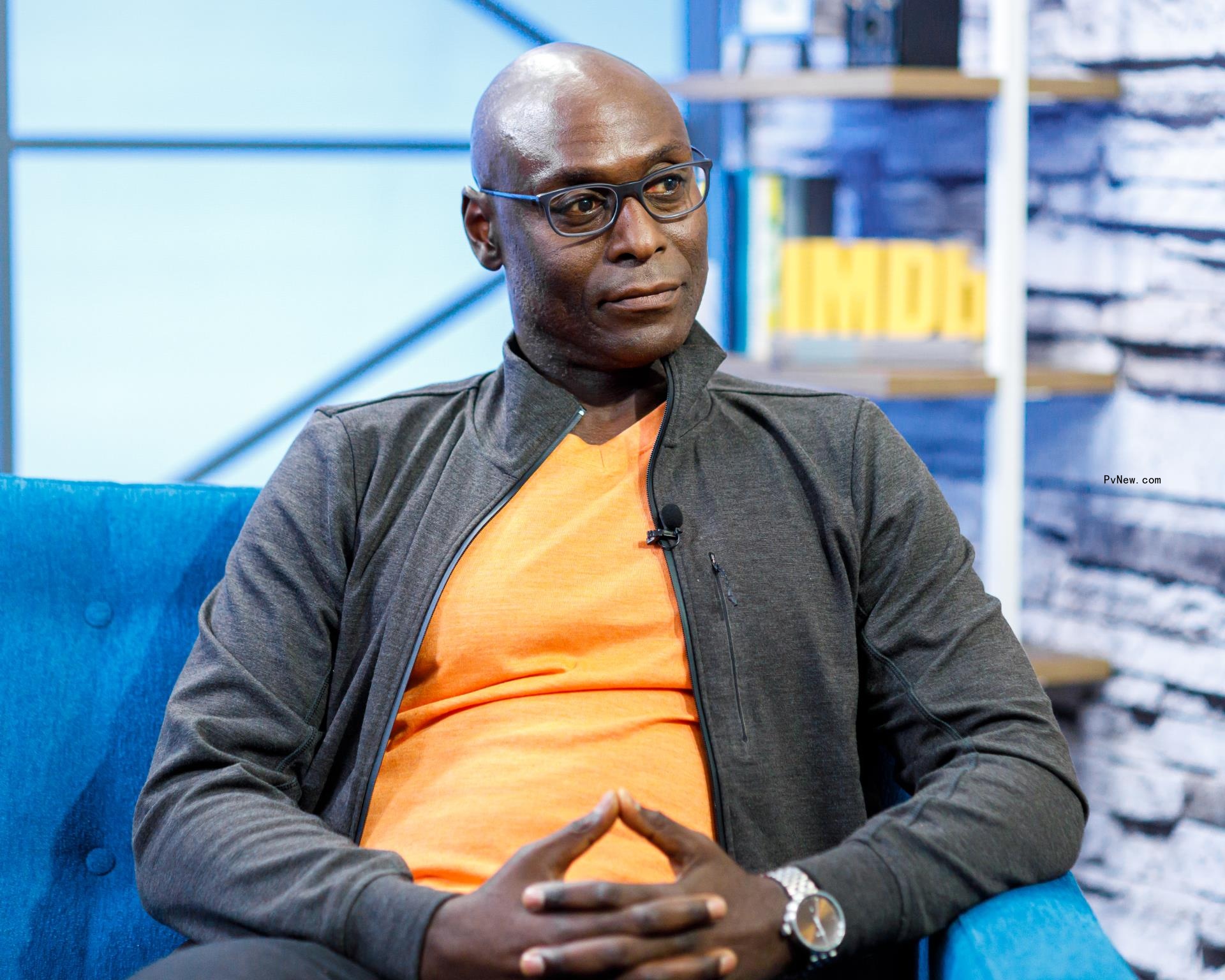 lance reddick sitting in a chair