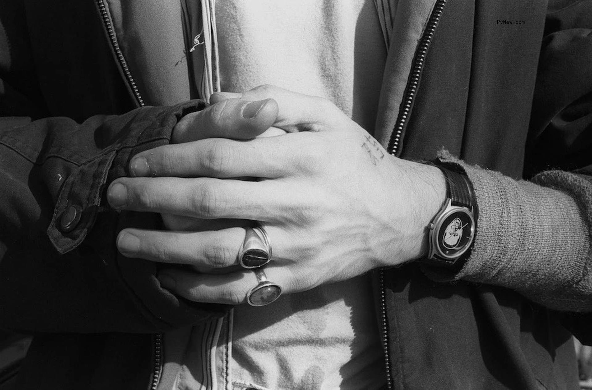 A close-up of Kurt Cobain's hands in a black-and-white photo