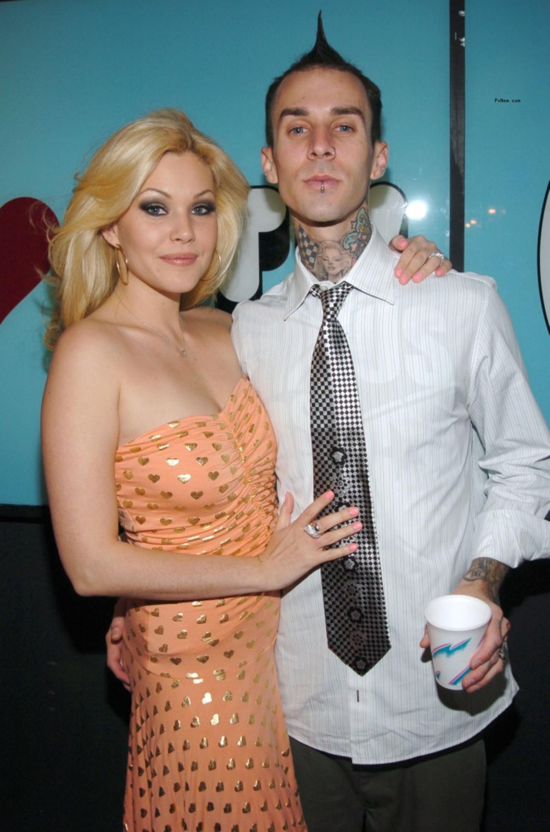 Shanna Moakler on right in orange dress Travis Barker on left in white shirt.