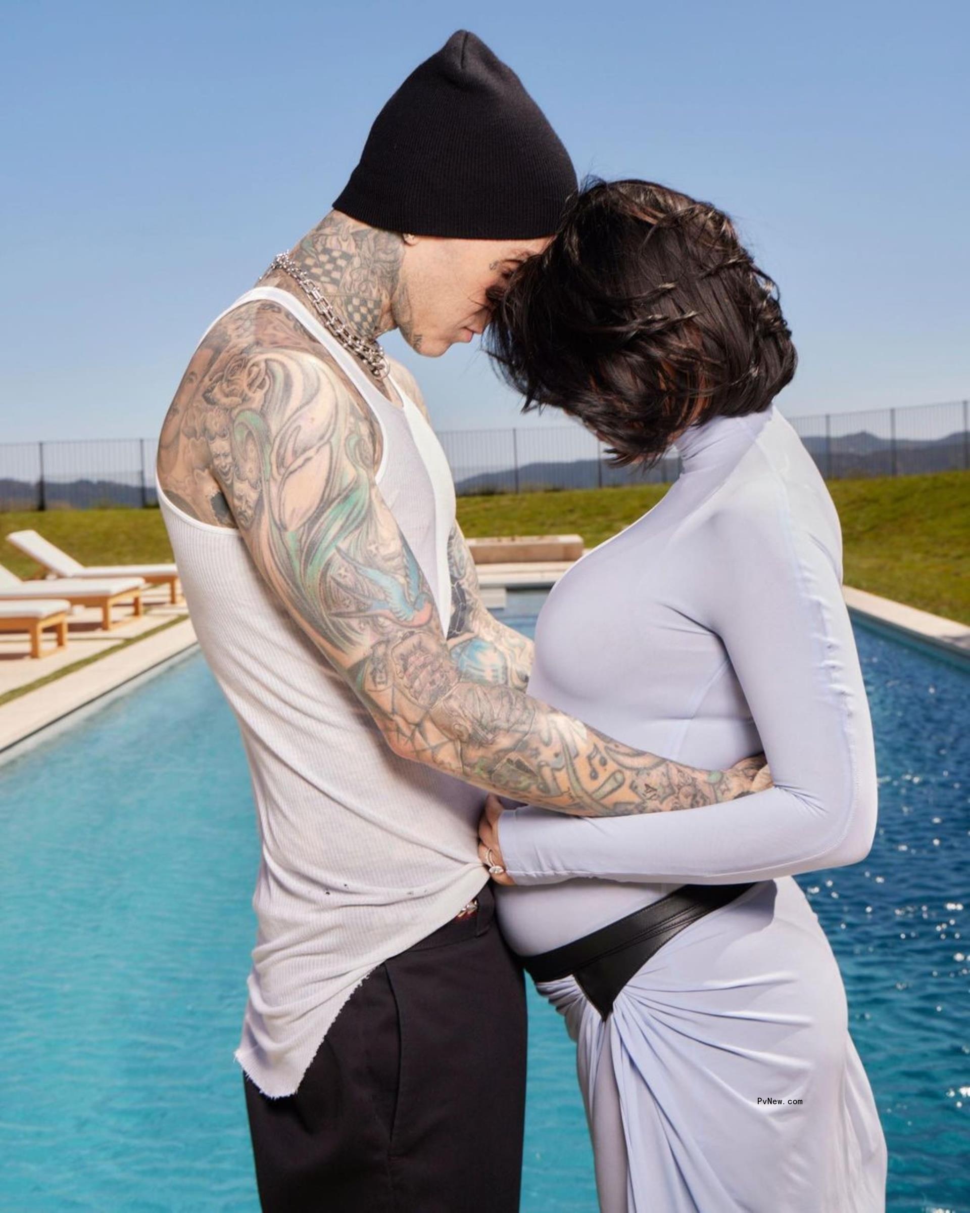 Travis Barker on left and Kourtney Kardashian on right both touching bowed heads.