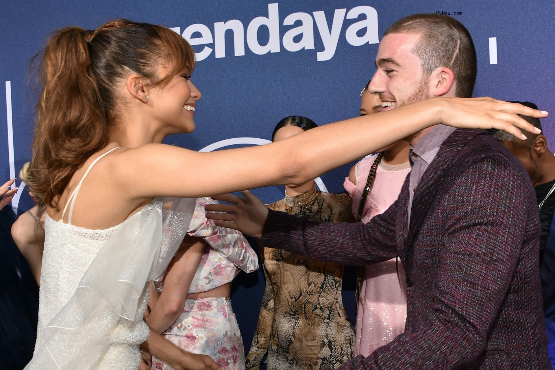 Zendaya going in for a hug with Angus Cloud
