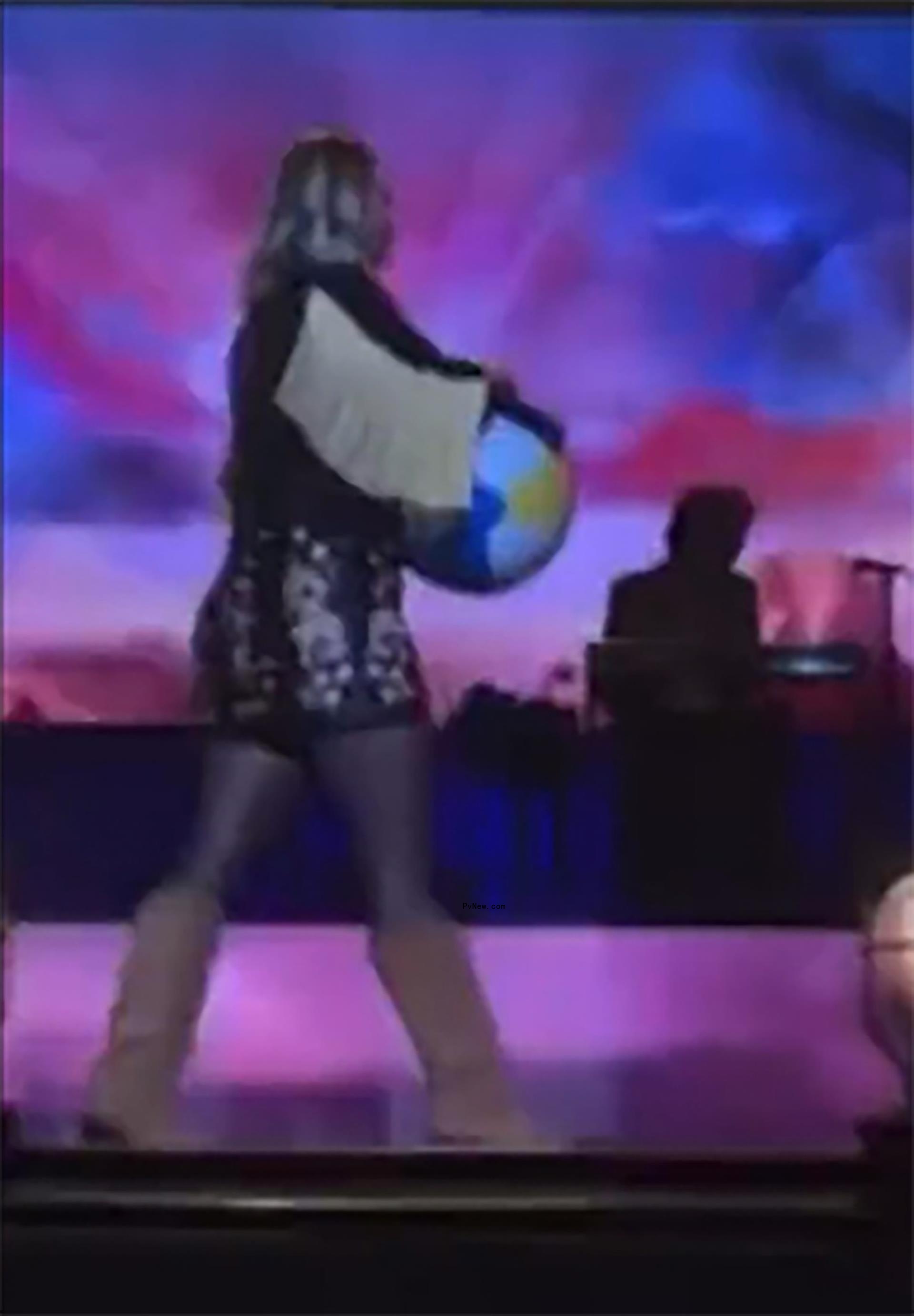 Miranda Lambert popping a beach ball.