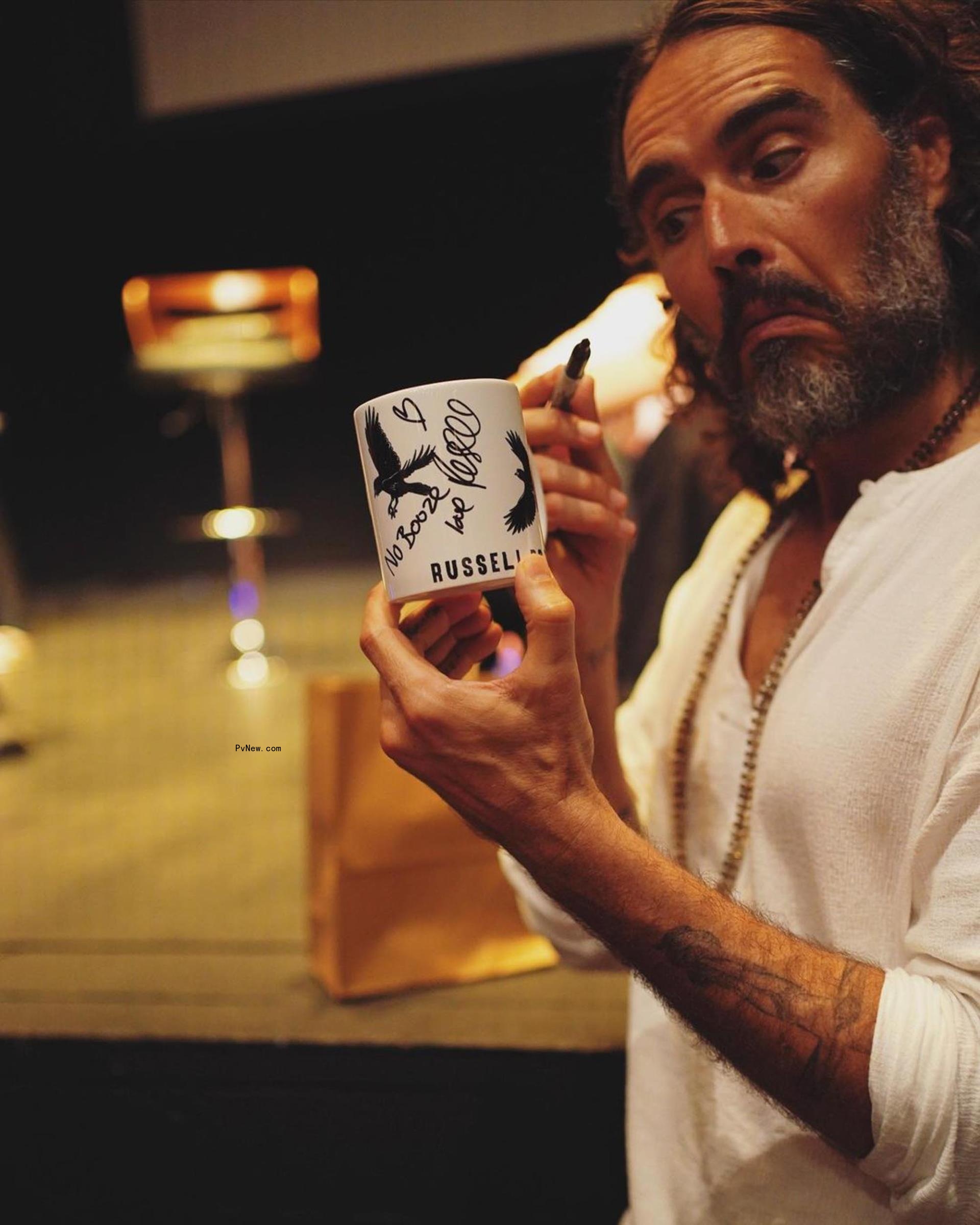 Russell Brand sitting