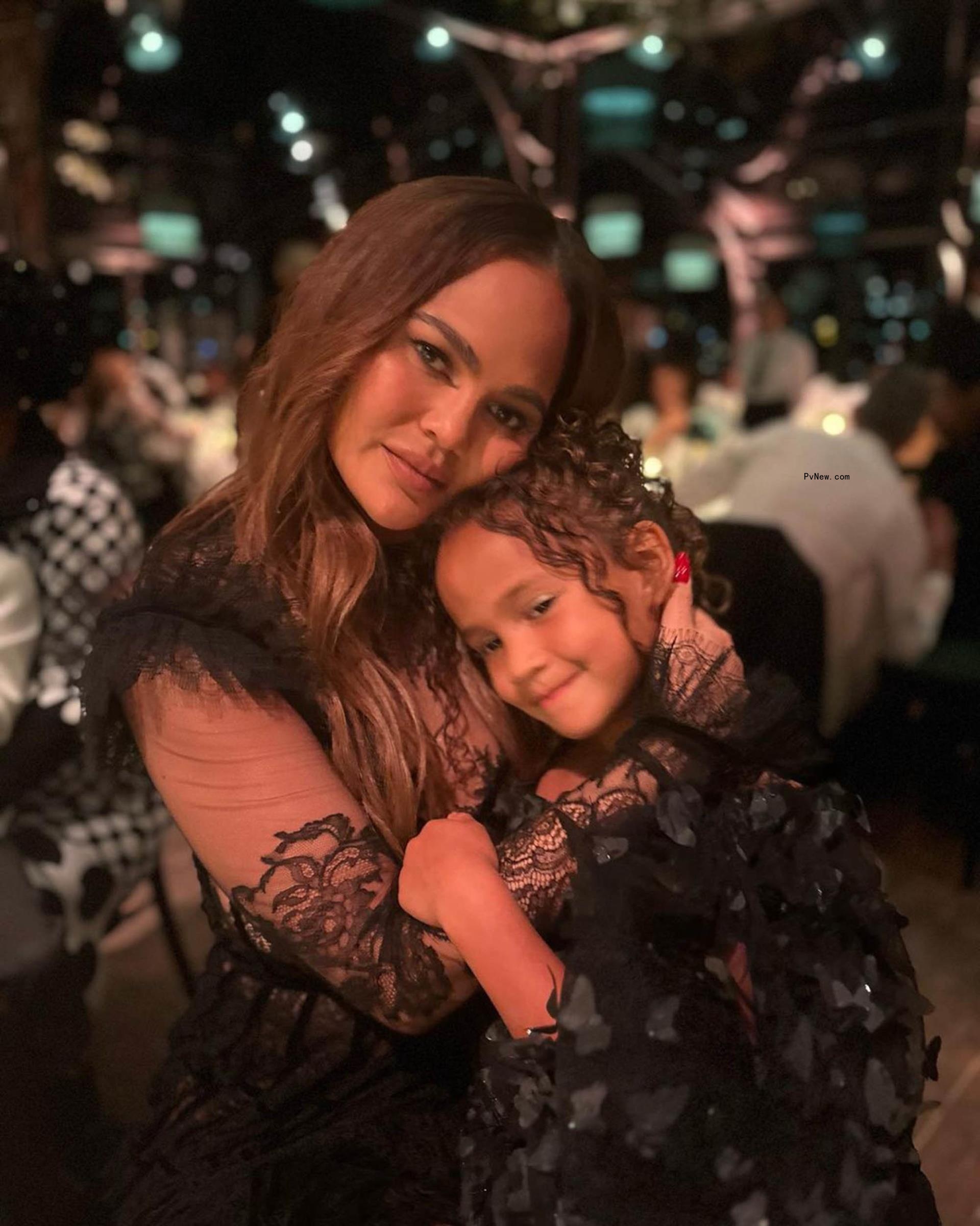 Chrissy Teigen holding daughter Luna