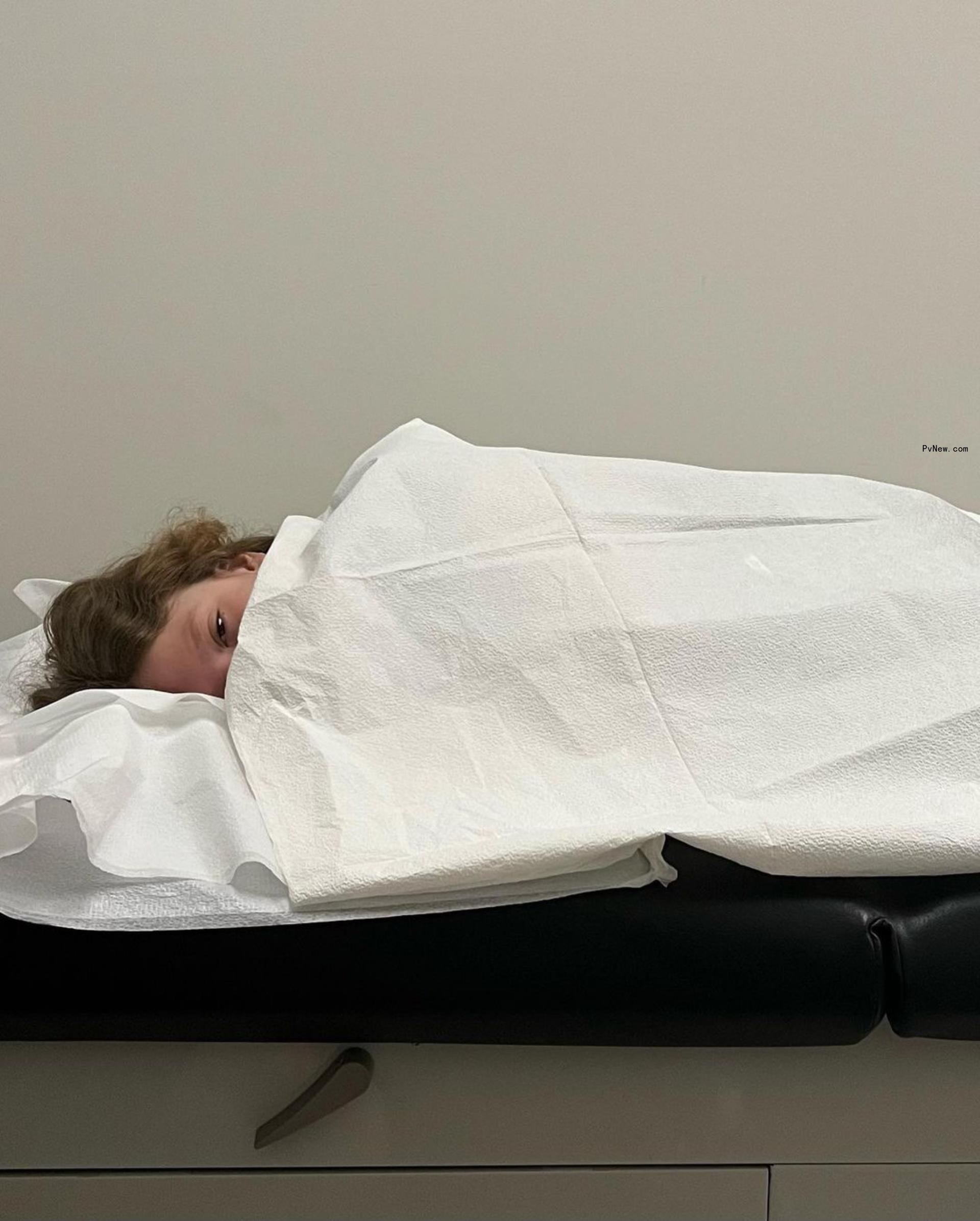 One of Tori Spelling's kids lying down in Urgent Care.