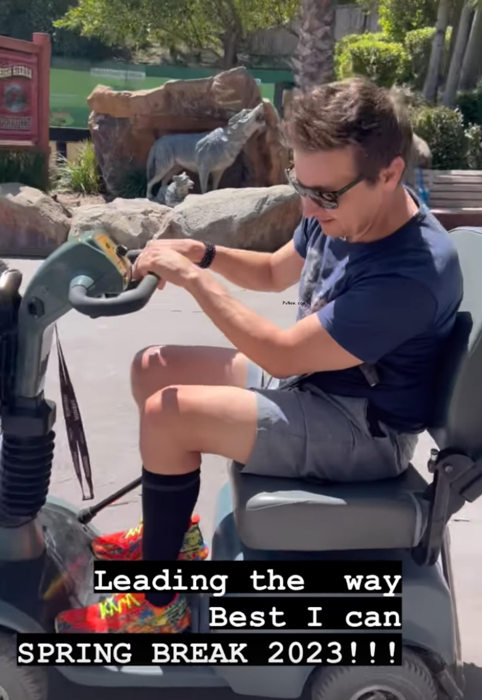 Jeremy Renner on an electric scooter at Six Flags.