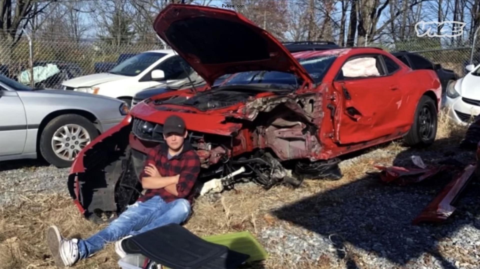 collin gosselin sitting in front of his banged up car