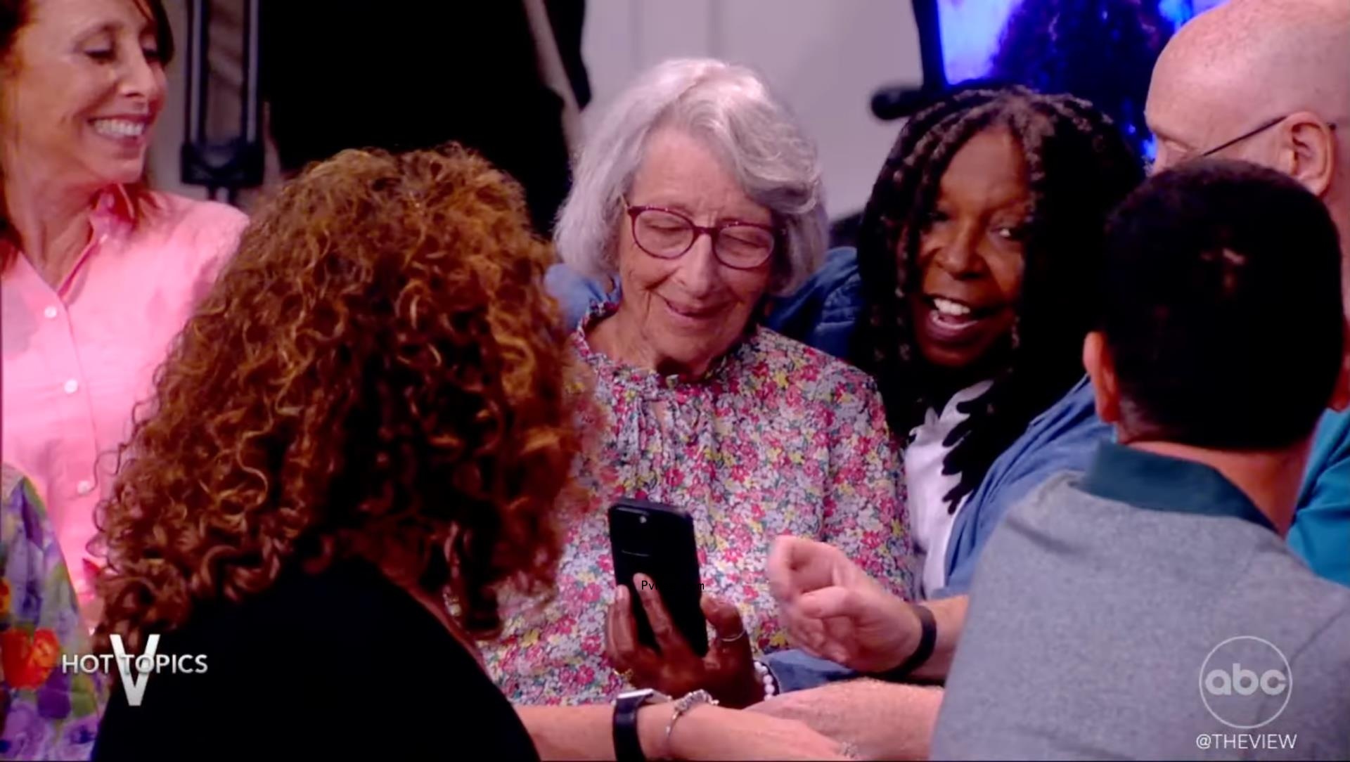 Whoopi Goldberg taking a selfie with an old woman