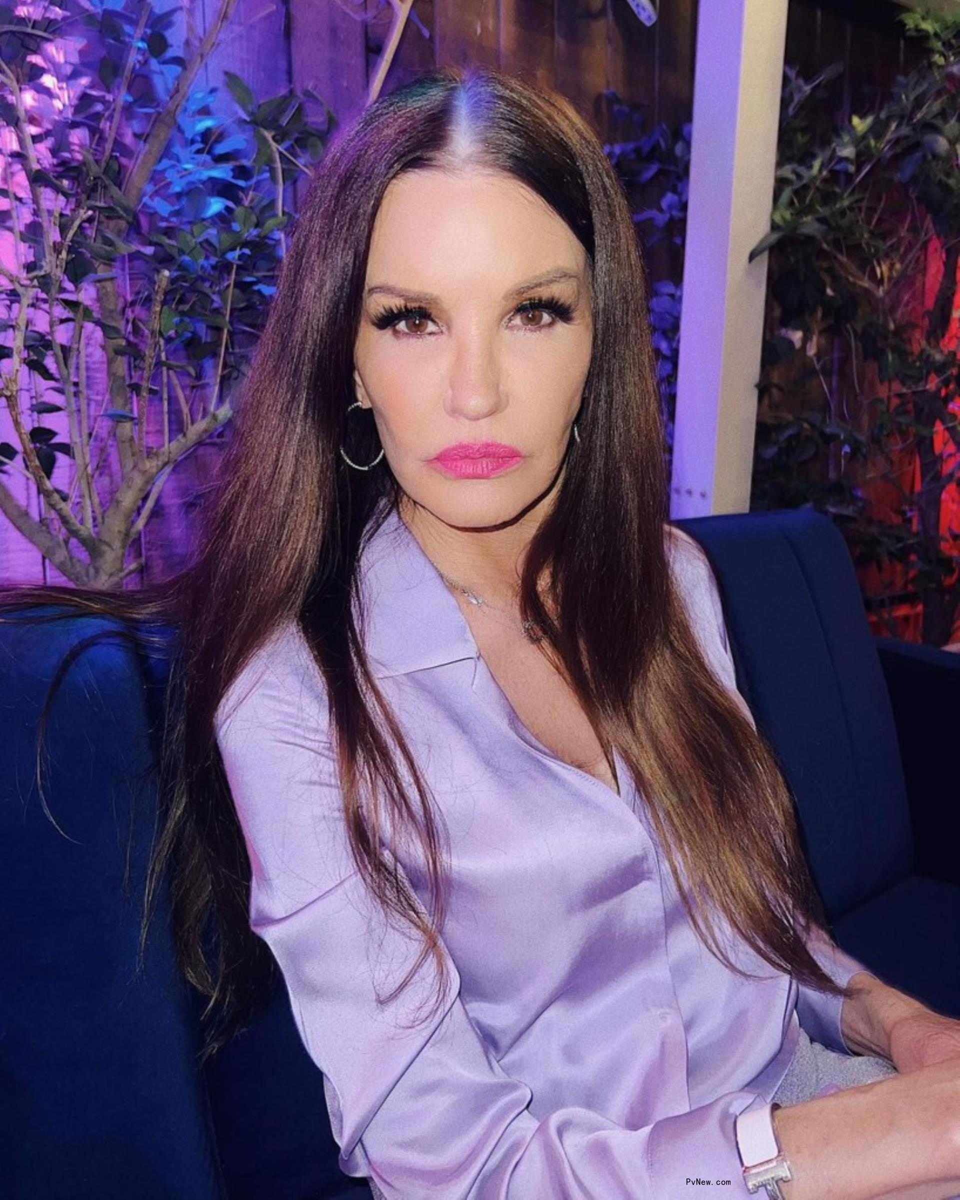 Janice Dickinson in a purple shirt.