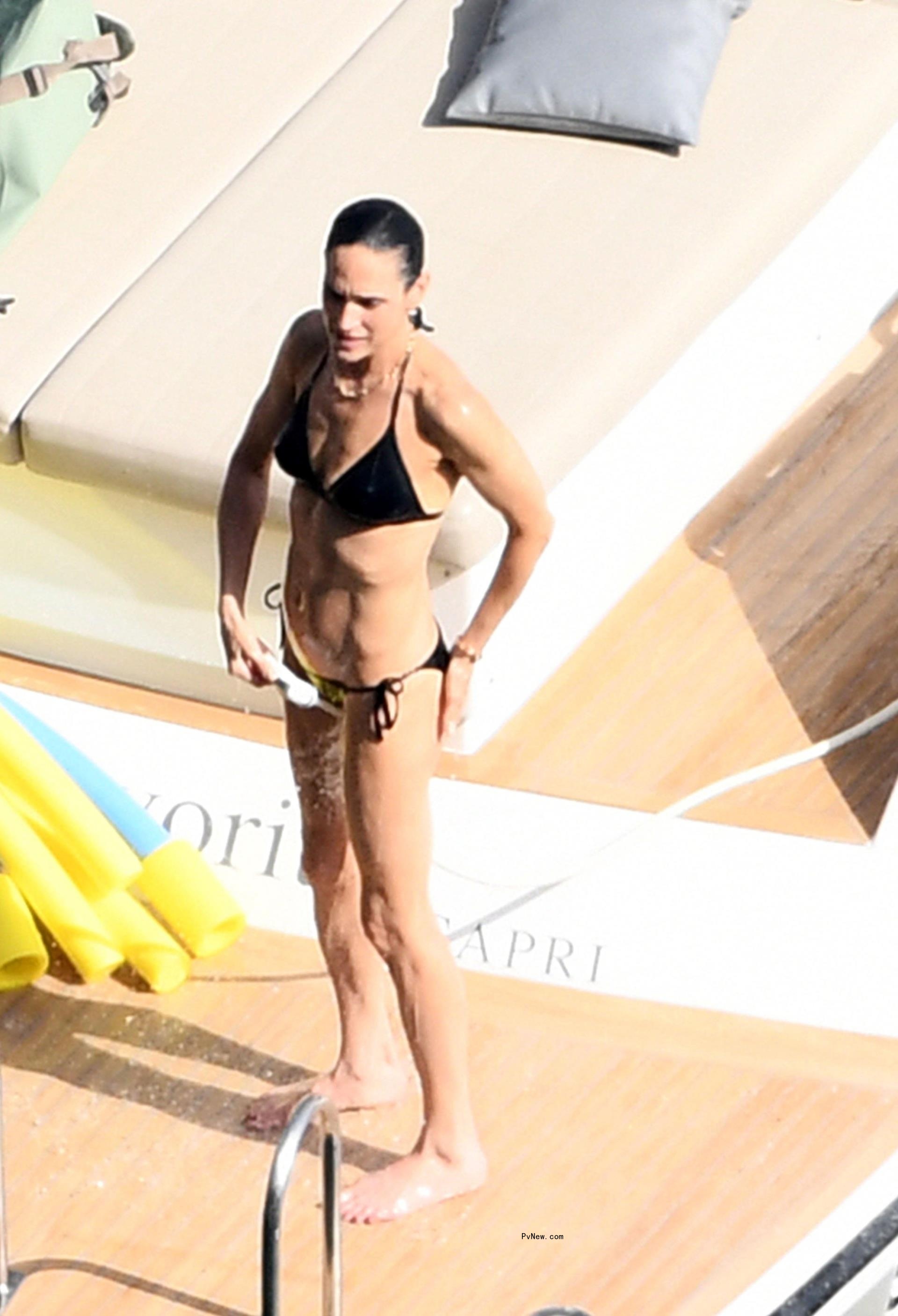 Jennifer Co<i></i>nnelly in a black bikini.