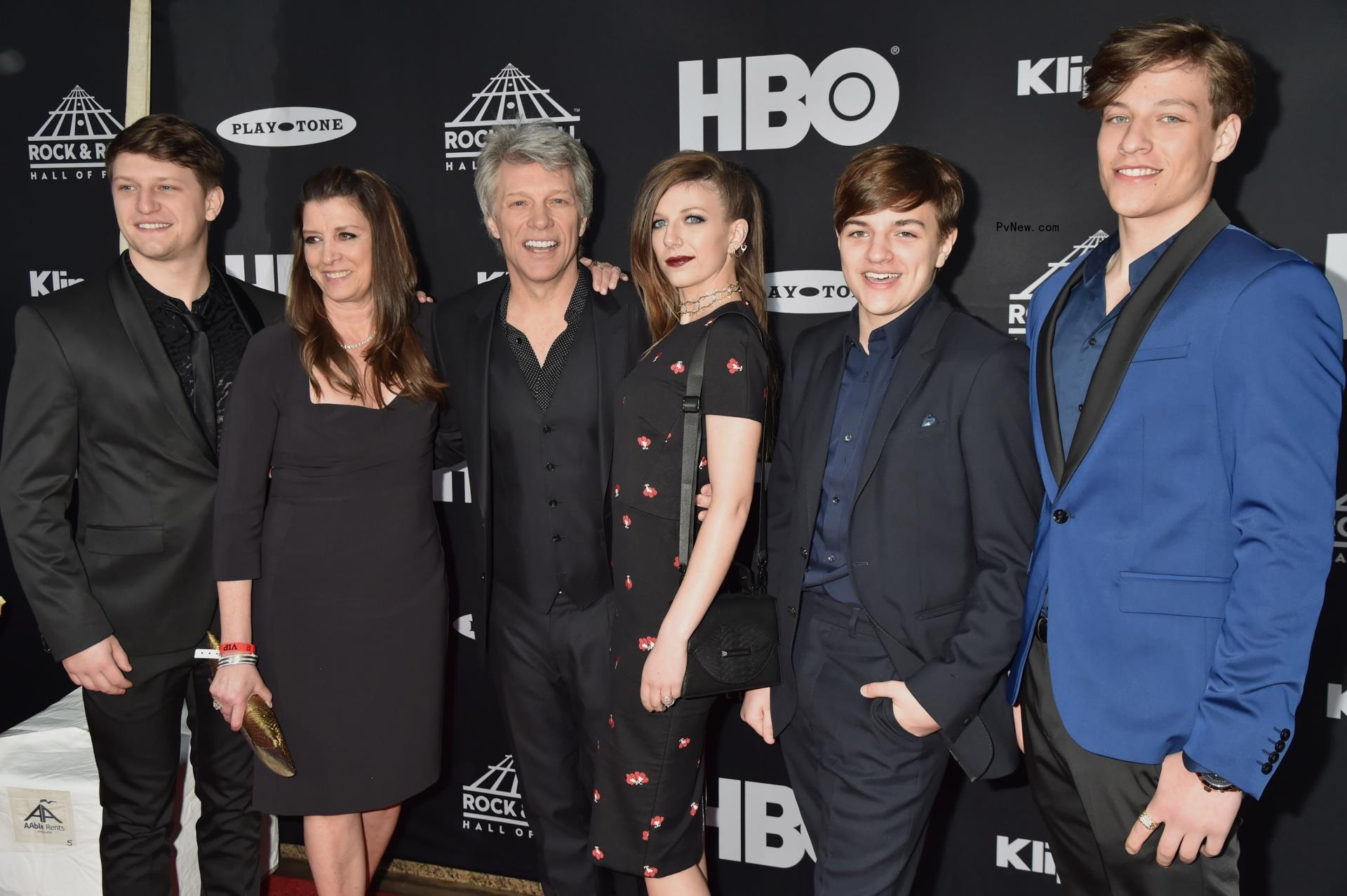 Jon Bon Jovi and Dorothea Hurley posing on a red carpet with their four kids.