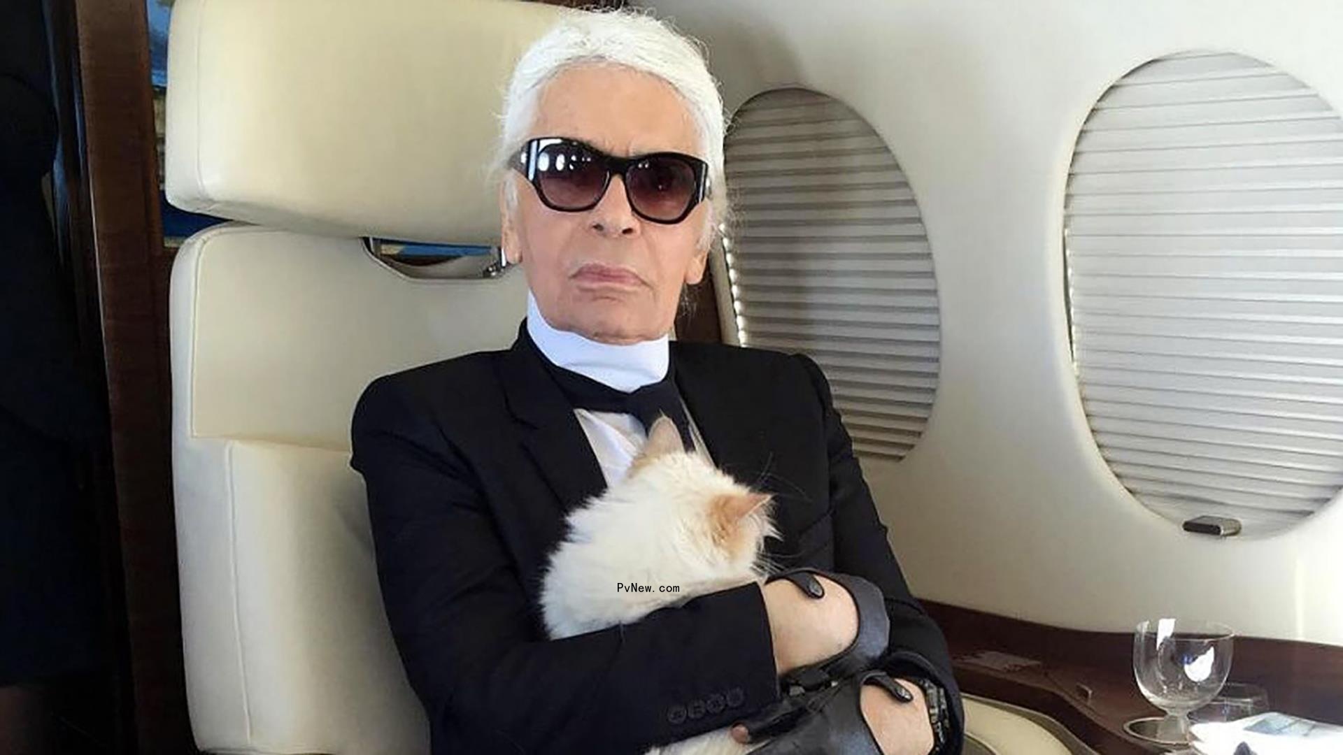 Karl Lagerfeld holding Choupette on a plane