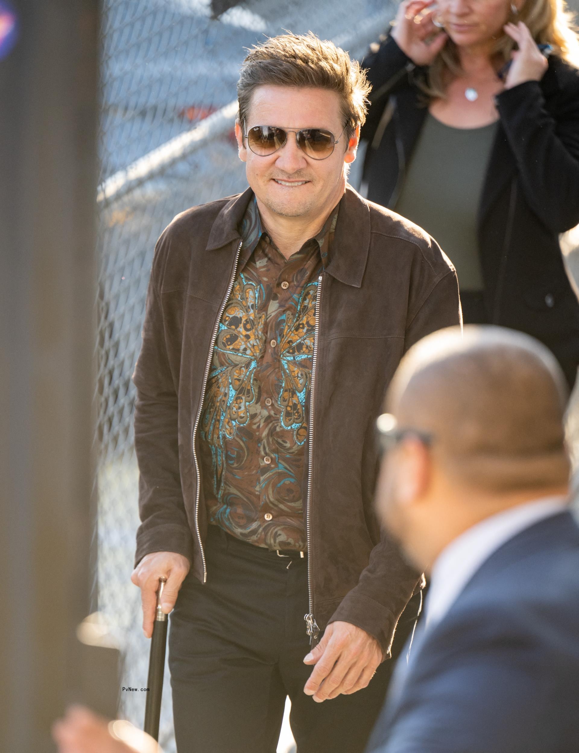 Jeremy Renner walks with cane