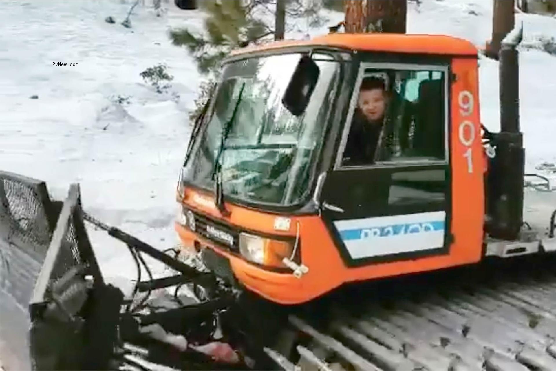Jeremy Renner rides in snowplow