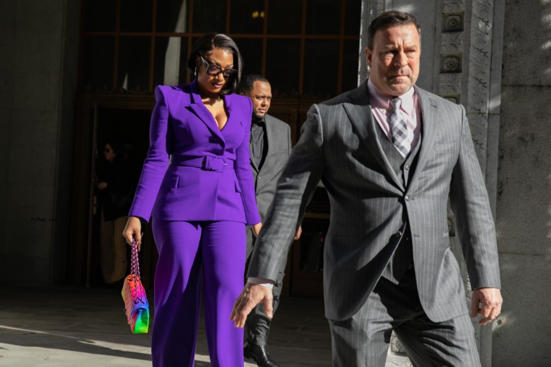 Megan Thee Stallion in purple suit leaving court.