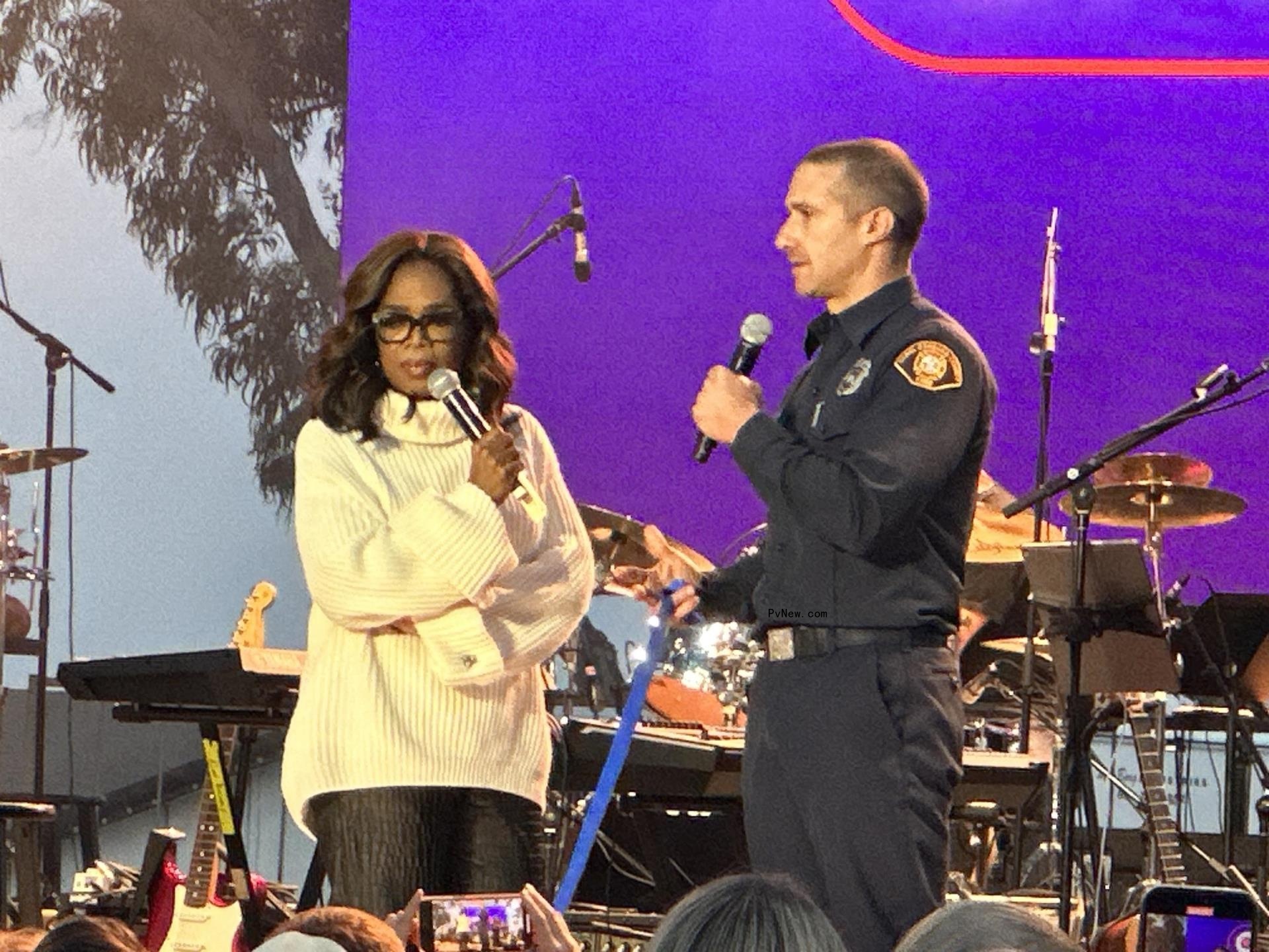Oprah Winfrey presenting an award at a One805 Live! event.