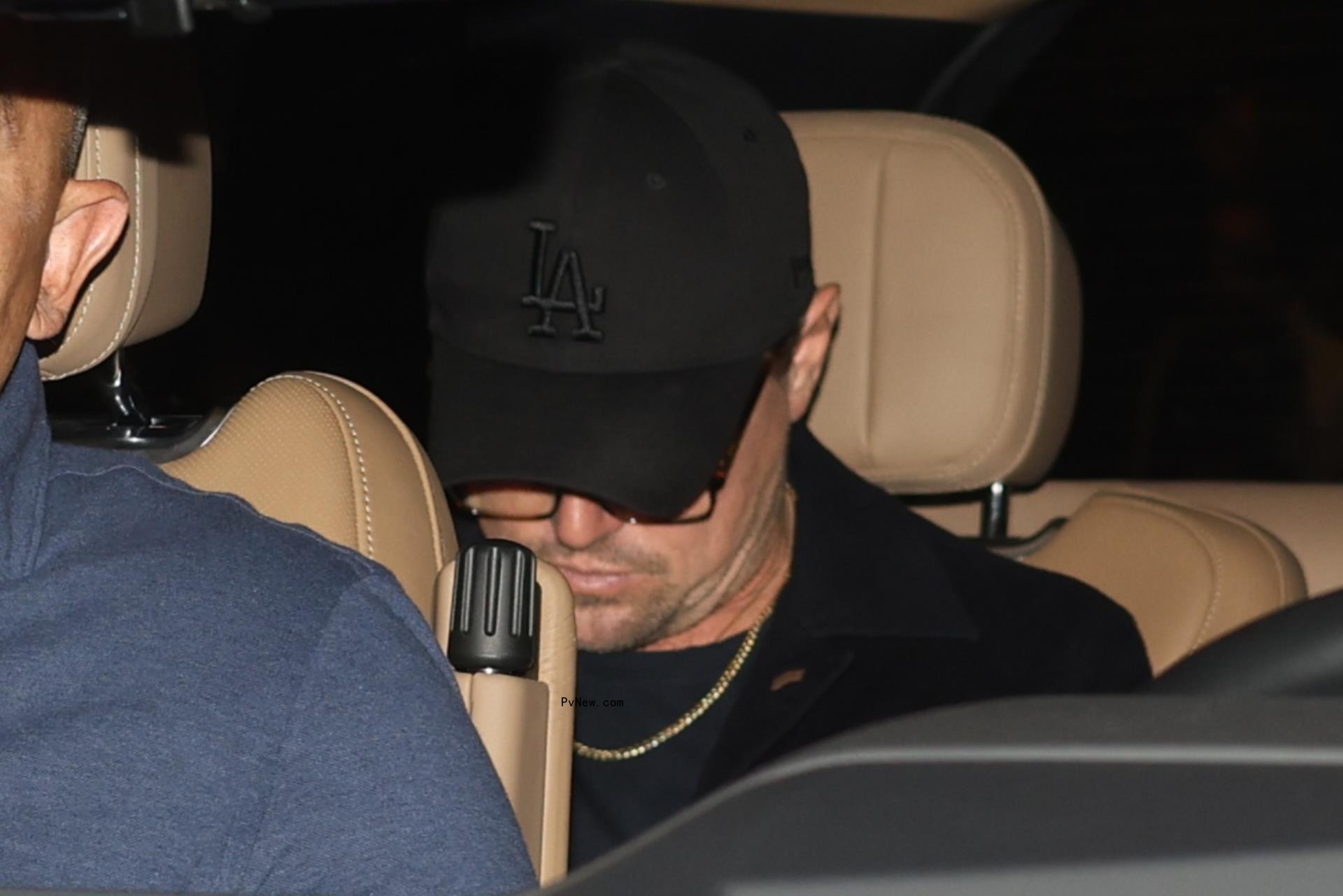 Leo<i></i>nardo DiCaprio in the back seat of a car.