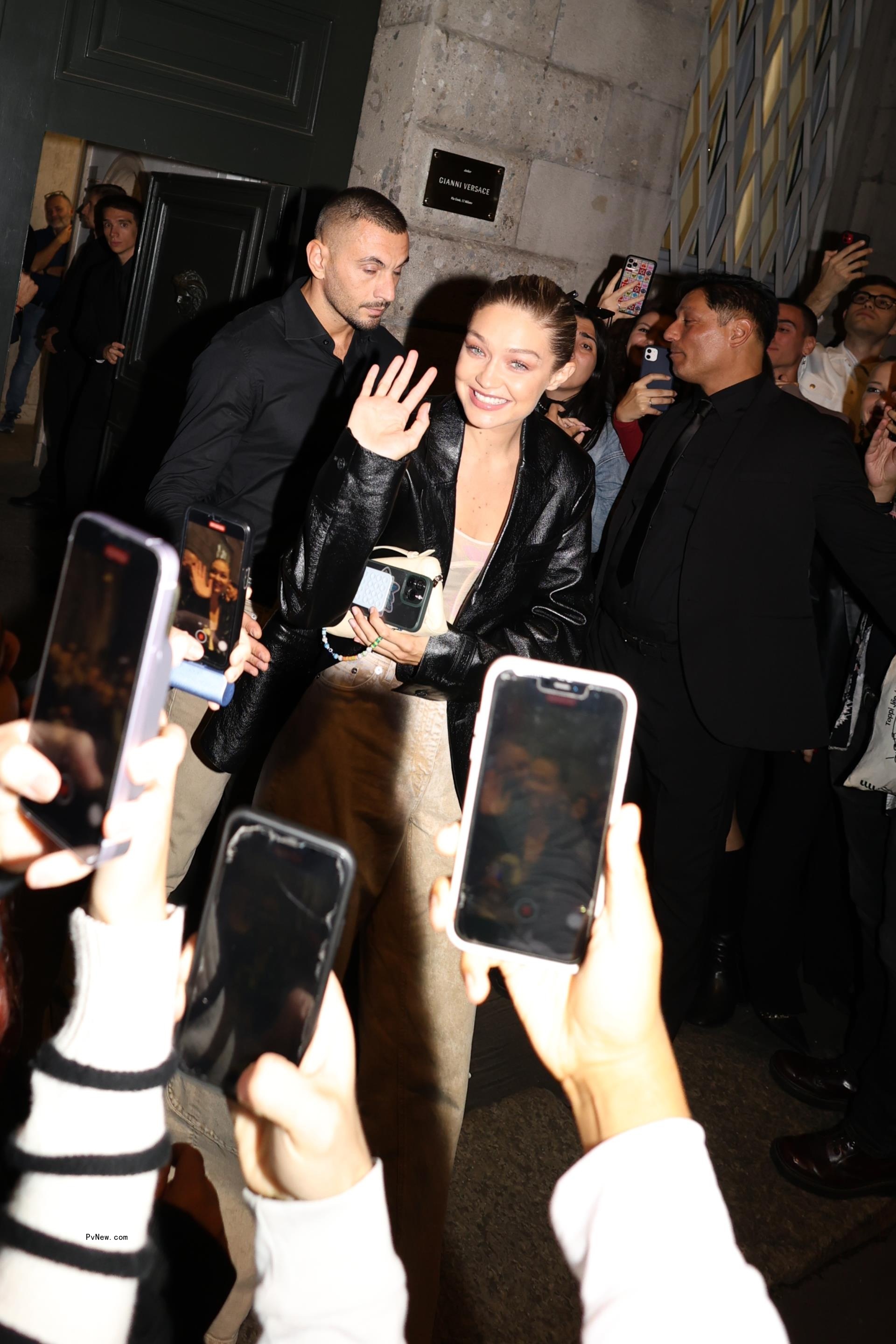 Gigi Hadid smiling as she is leaving Versace's party.