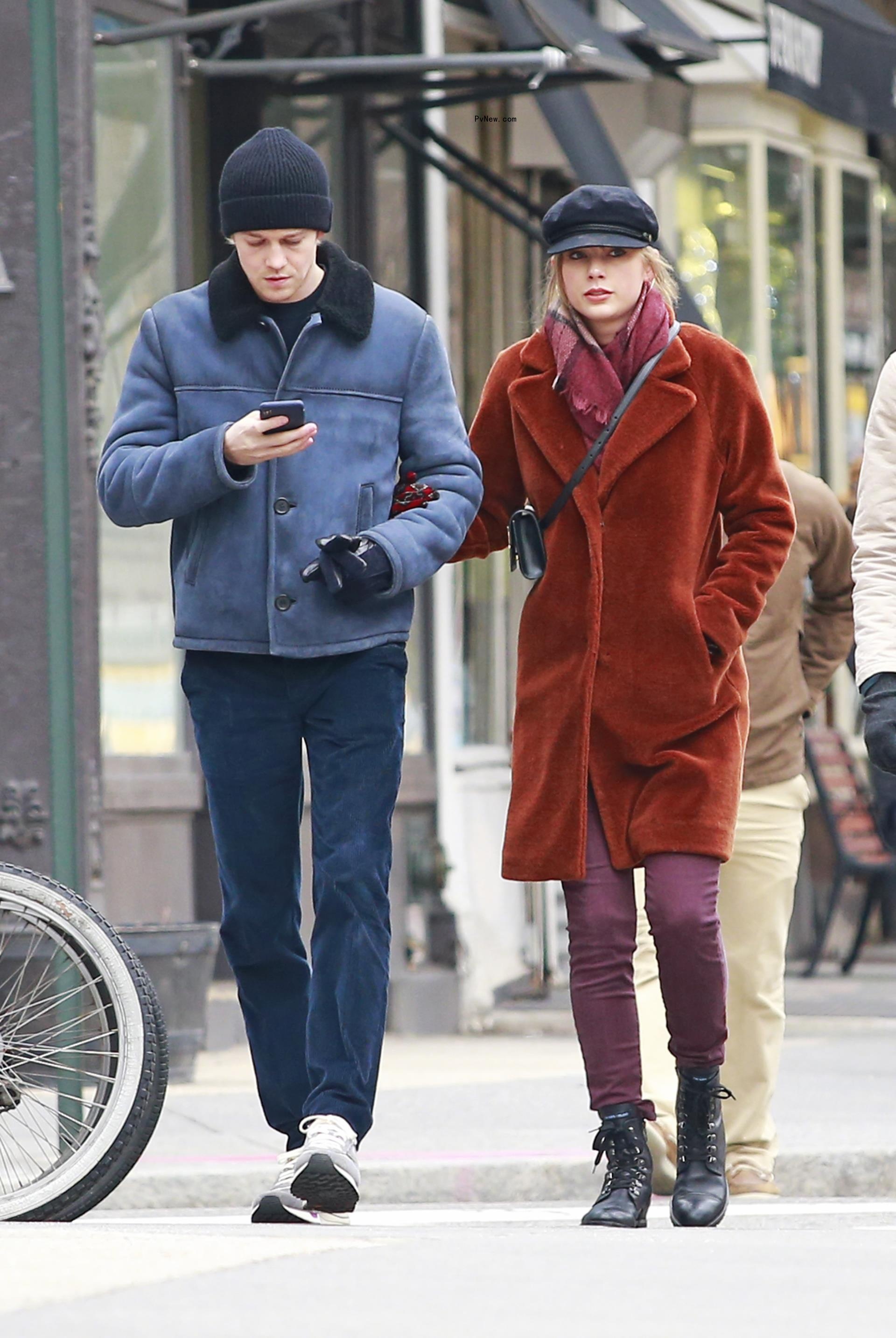 Joe Alwyn and Taylor Swift walking together in the streets of New York City.