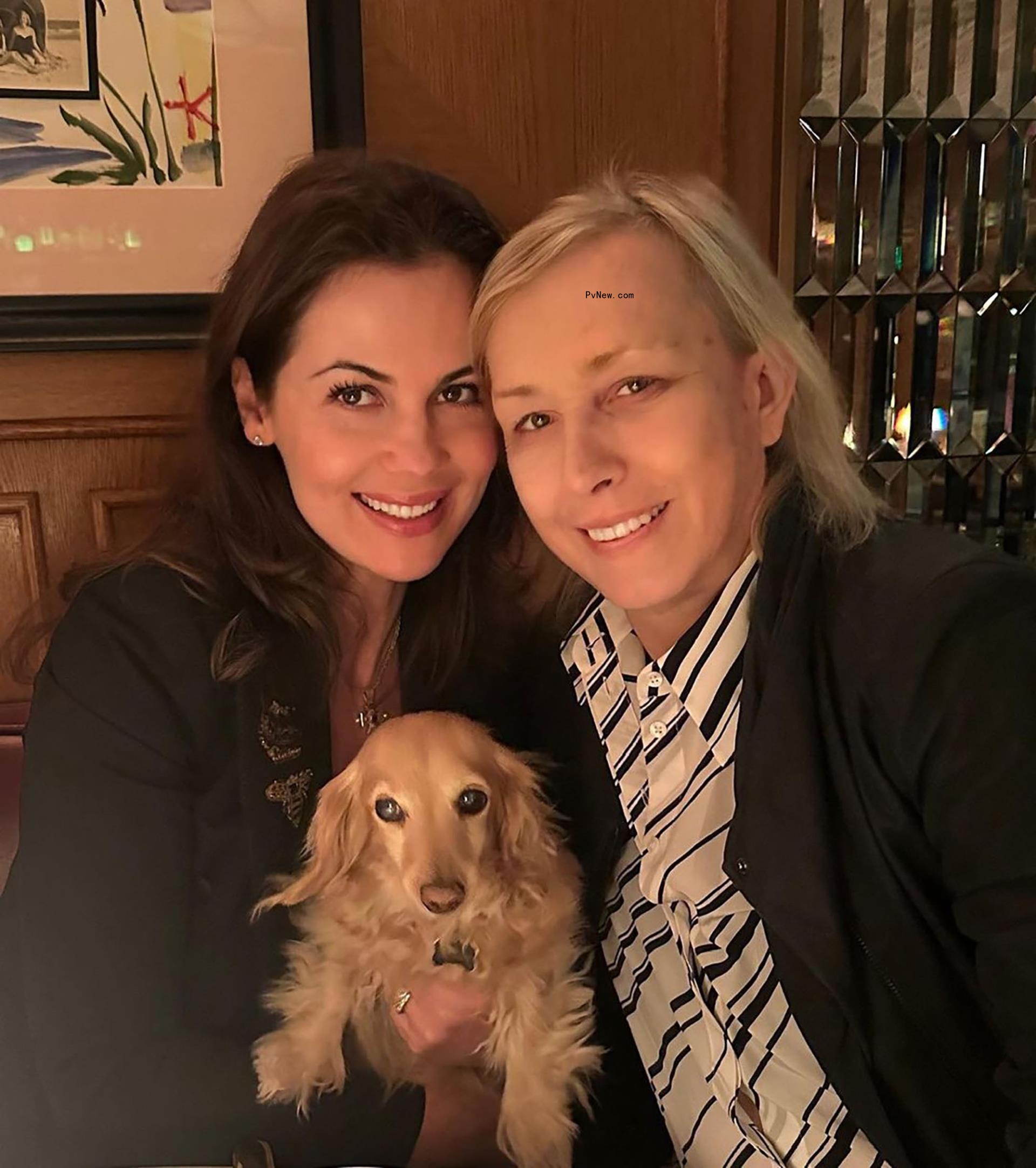 Julia Lemigova, Martina Navratilova posing with their dog