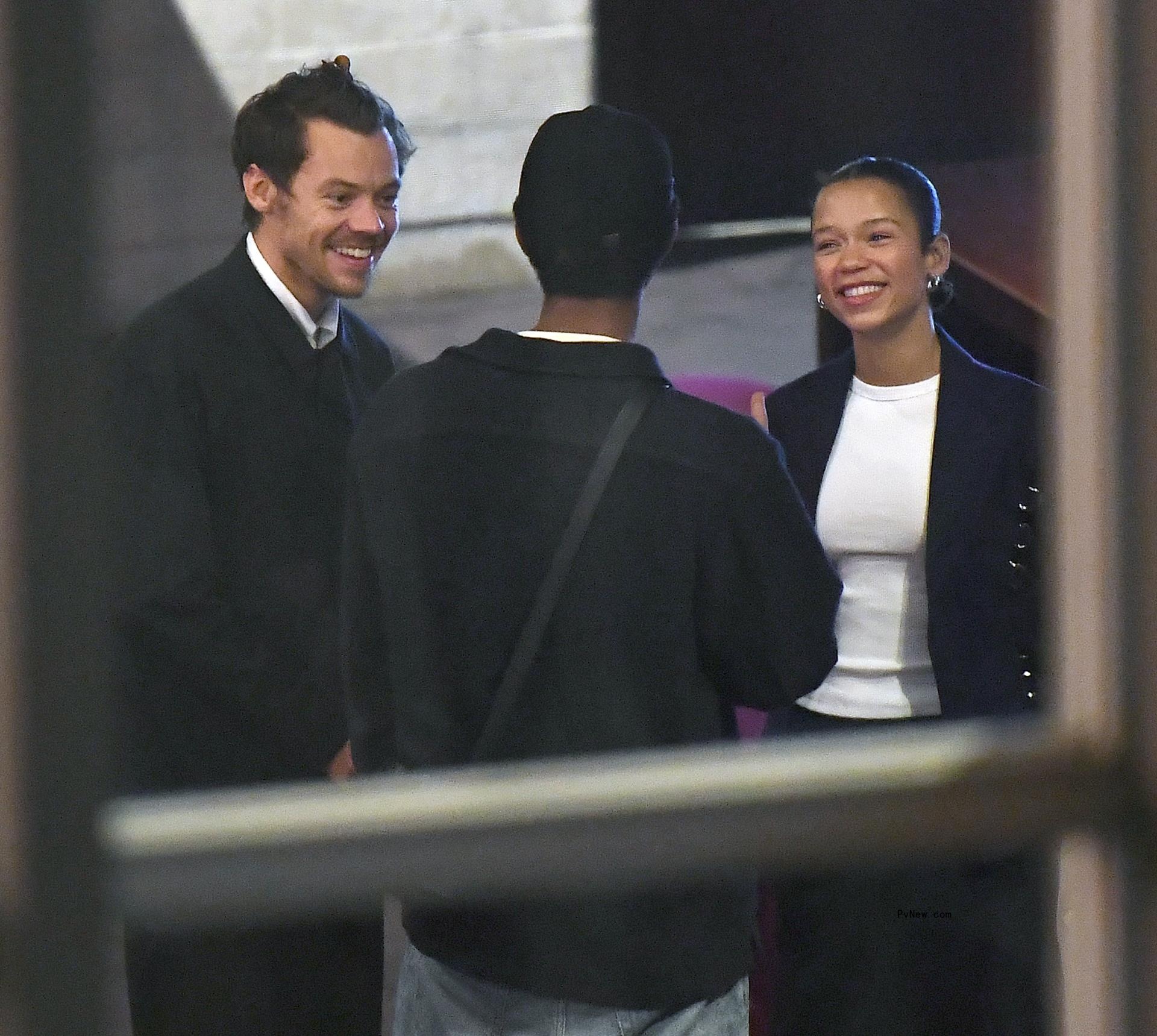 Harry Styles, Taylor Russell smiling.
