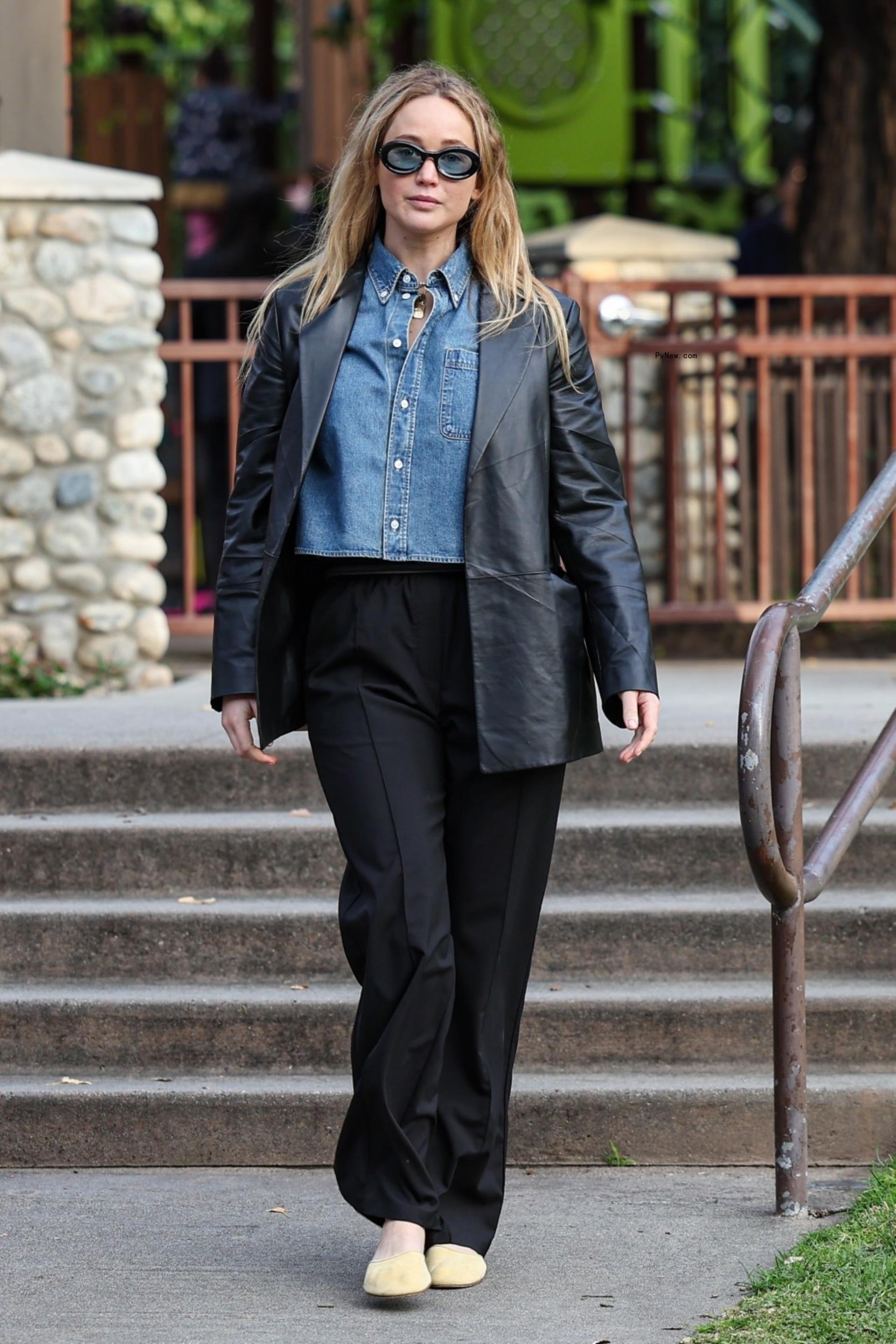 Actress Jennifer Lawrence was spotted enjoying some solitary time at Coldwater Park in Beverly Hills, looking effortlessly chic in a black leather blazer, a blue denim shirt, black trousers, and beige flats.