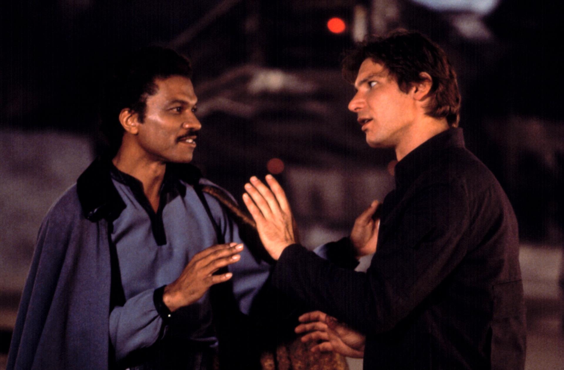 Billy Dee Williams, as Lando Calrissian, talking with Harrison Ford, as Han Solo, in
