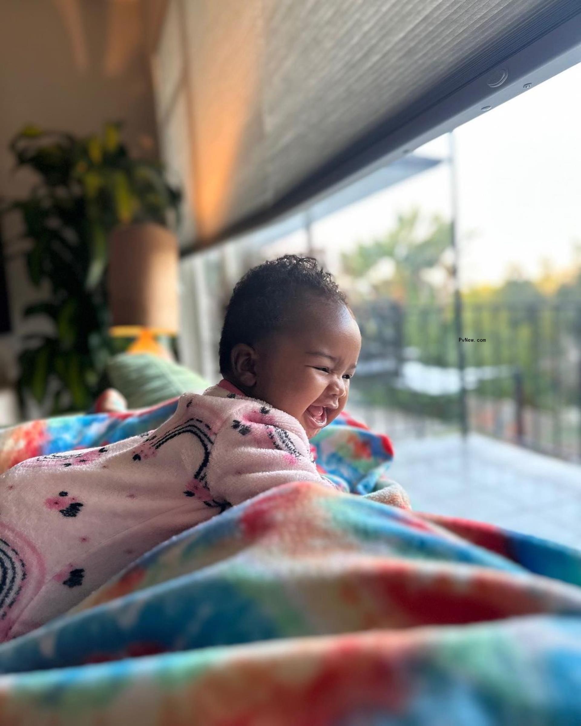 Nick Cannon's daughter o<i></i>nyx smiles in rainbow onesie