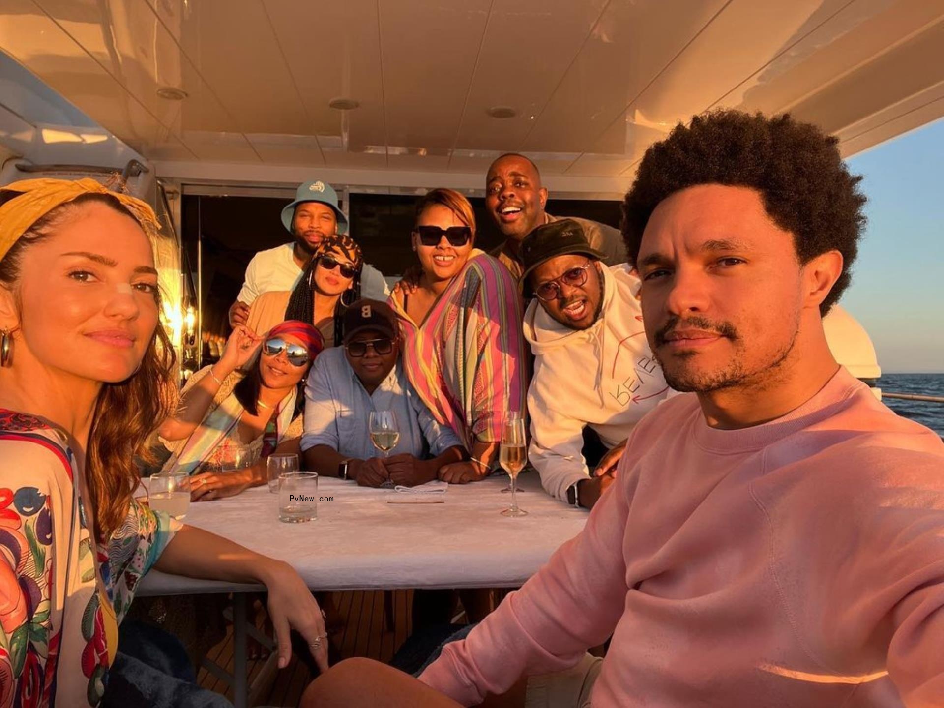 Minka Kelly and Trevor Noah on a boat with friends