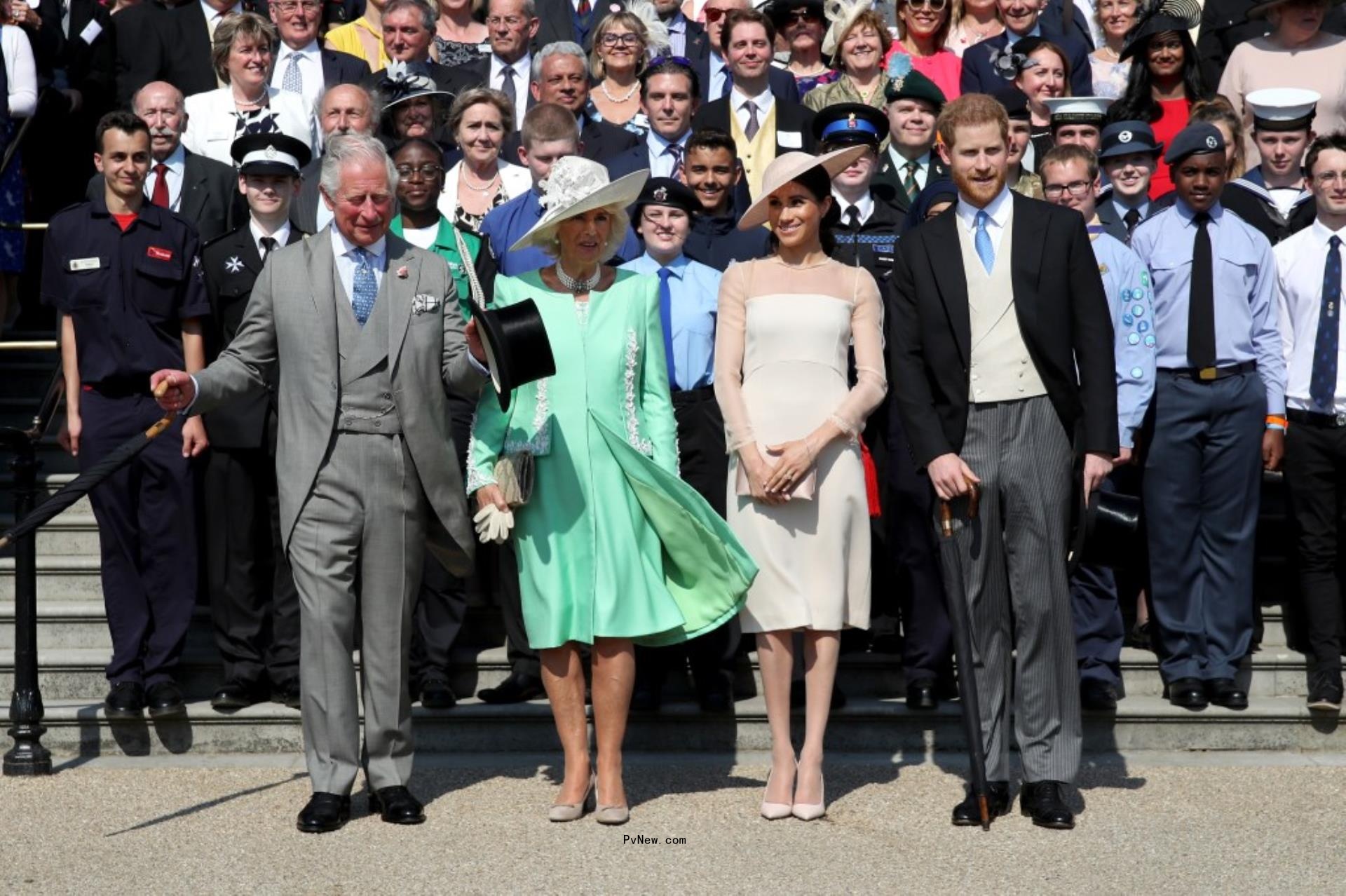 Prince Harry and Meghan Markle standing with his dad King Charles and his wife, Queen Camilla.