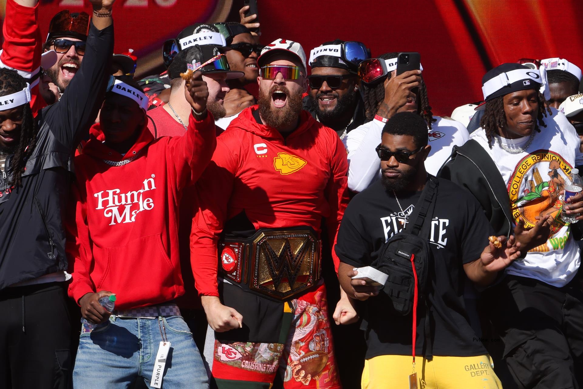 Travis Kelce #87 of the Kansas City Chiefs celebrates on stage with teammates during the Kansas City Chiefs Super Bowl LVIII victory parade on February 14, 2024 in Kansas City, Missouri.