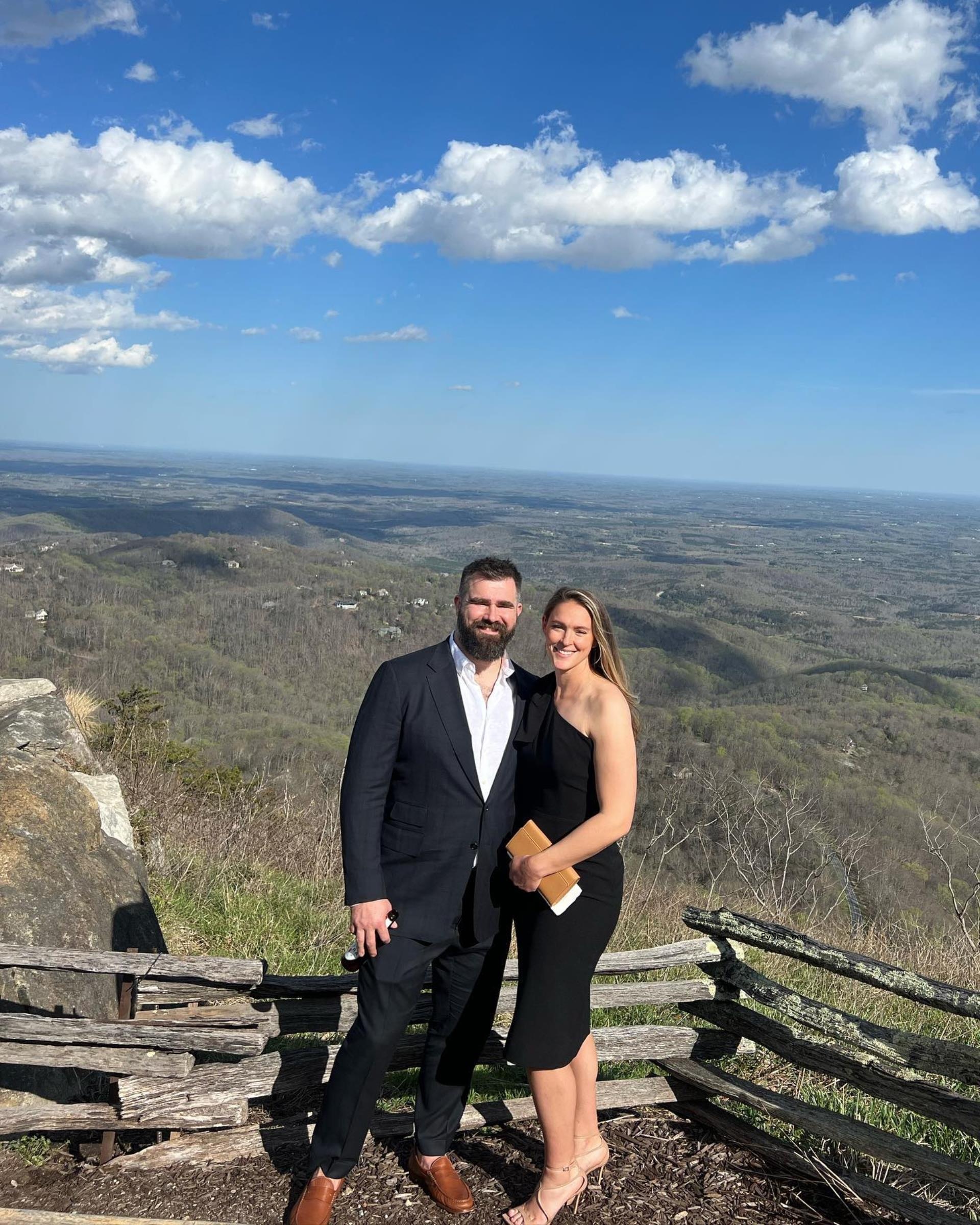 jason kelce and kylie kelce posing over a scenic landscape