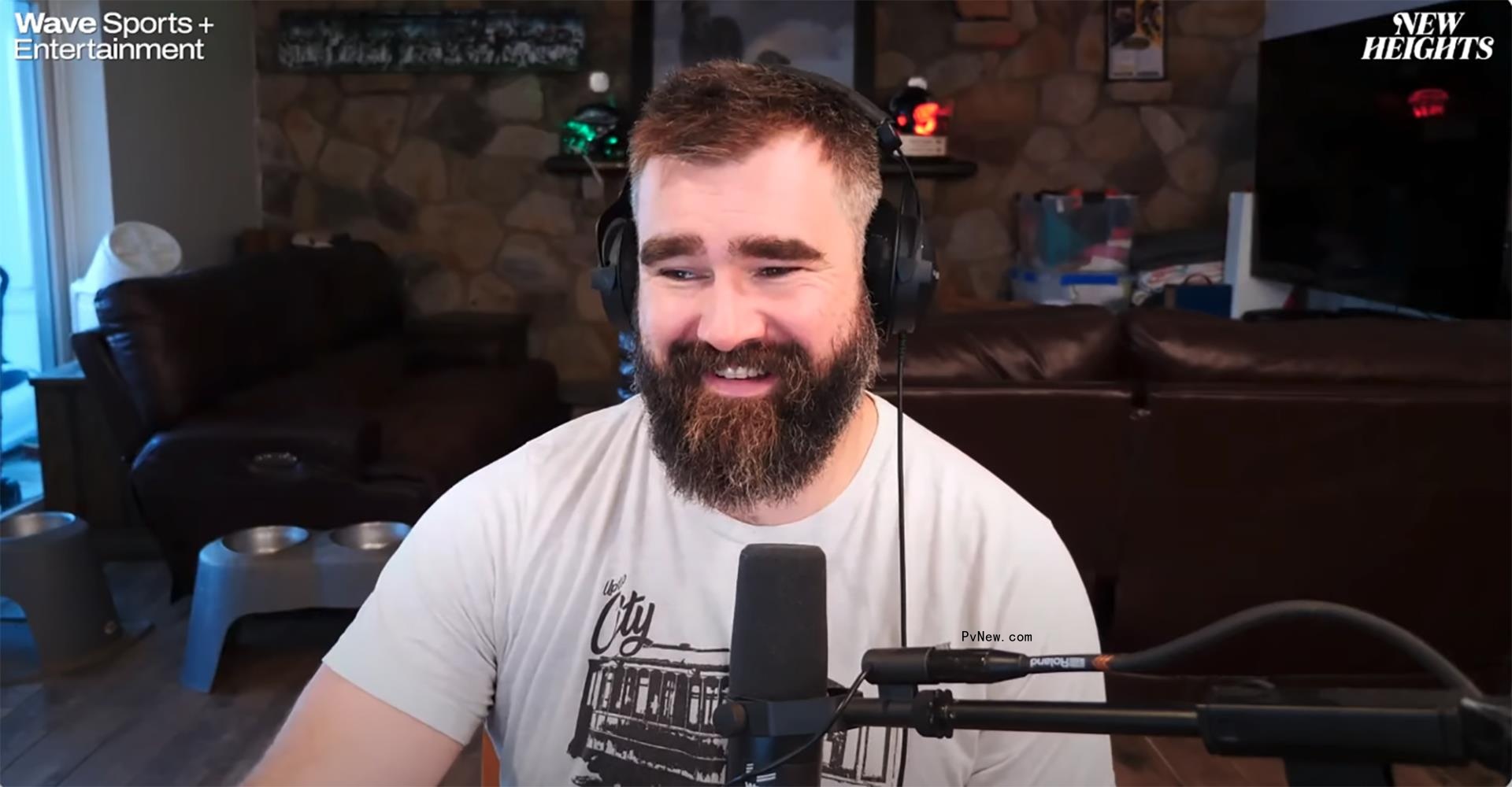 jason kelce talking into a microphone and smiling