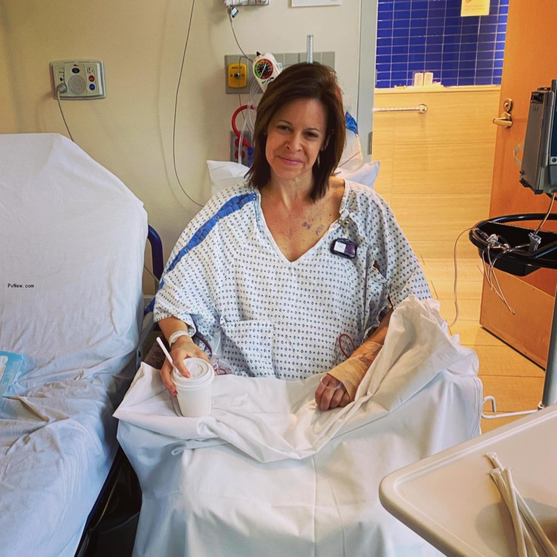 jenna wolfe in a hospital gown sitting in a chair