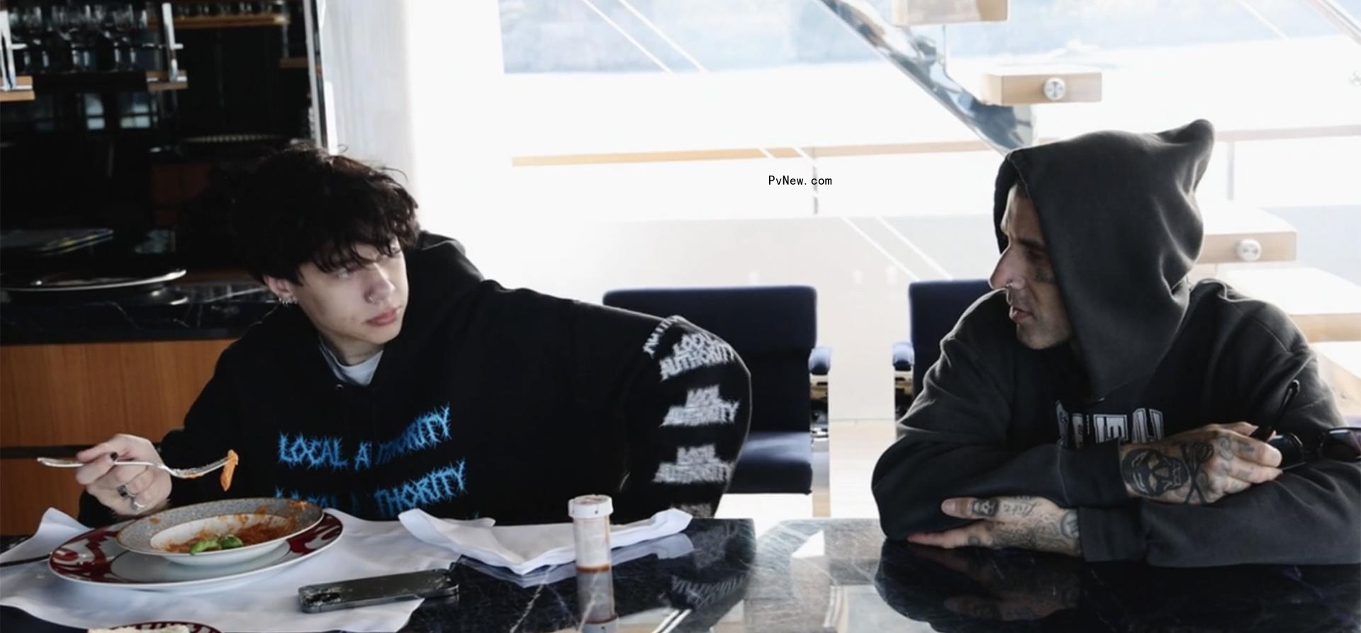 Trabis Barker sits with son Landon