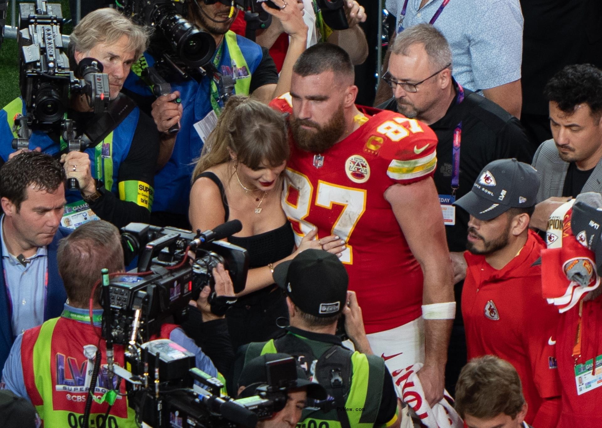Travis Kelce and Taylor Swift on the field after his Super Bowl LVIII win.